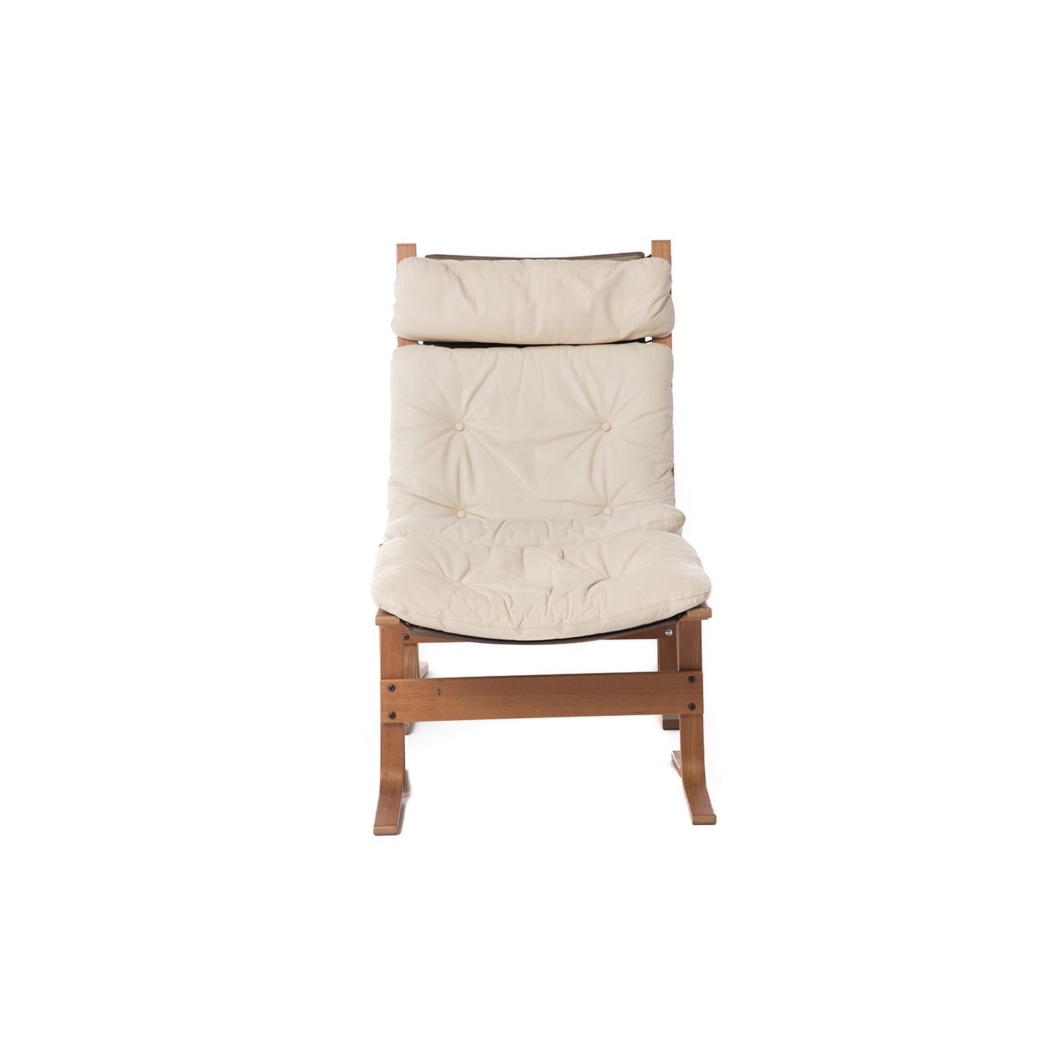 This Classic 1970s Scandinavian modern design from Norway is as comfortable as it is good looking. This lounge and ottoman are made of teak with a natural hemp sling with black grommets and lacing. The off-white leather cushions are original- supple