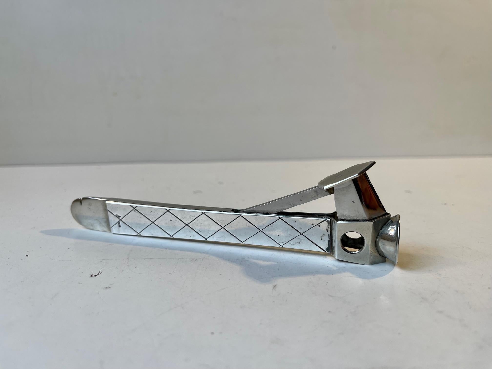 By an unknown Scandinavian Silversmith. Fine cigar cutter executed with handle in 925 sterling silver (signed and hallmarked). Cutting mechanism executed in stainless German steel. Made during the 1950s in either Denmark or Sweden. Measurements: L: