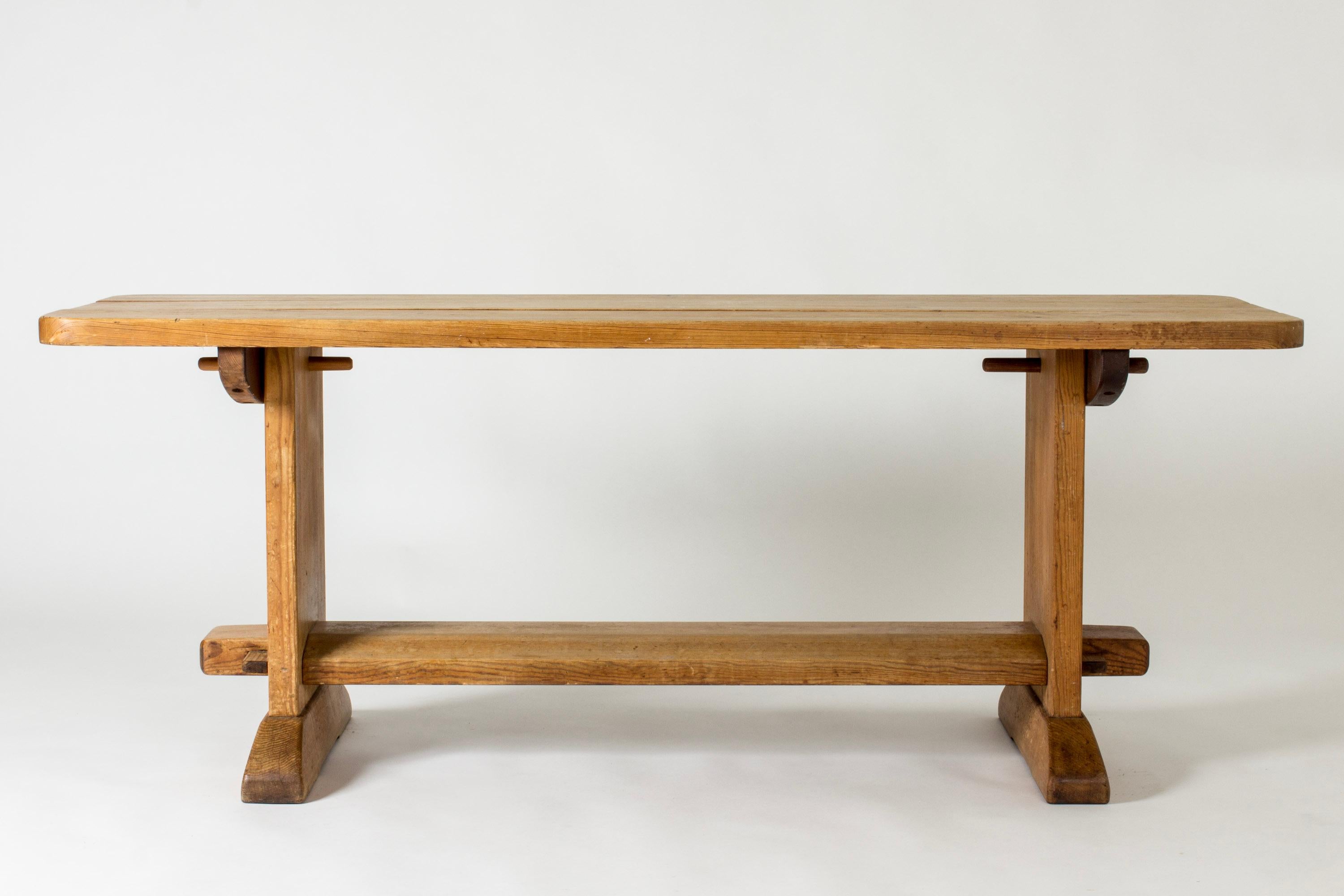 Rustic “Skoga” dining table by Axel Einar Hjorth, made from pine. Chunky rounded lines.