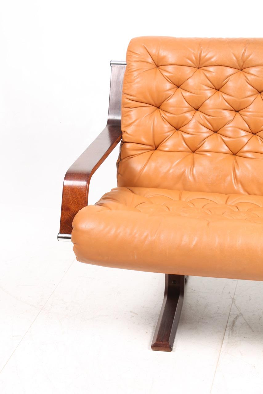 Two-seat sofa in patinated leather designed and made in Denmark in the 1970s. Great original condition.