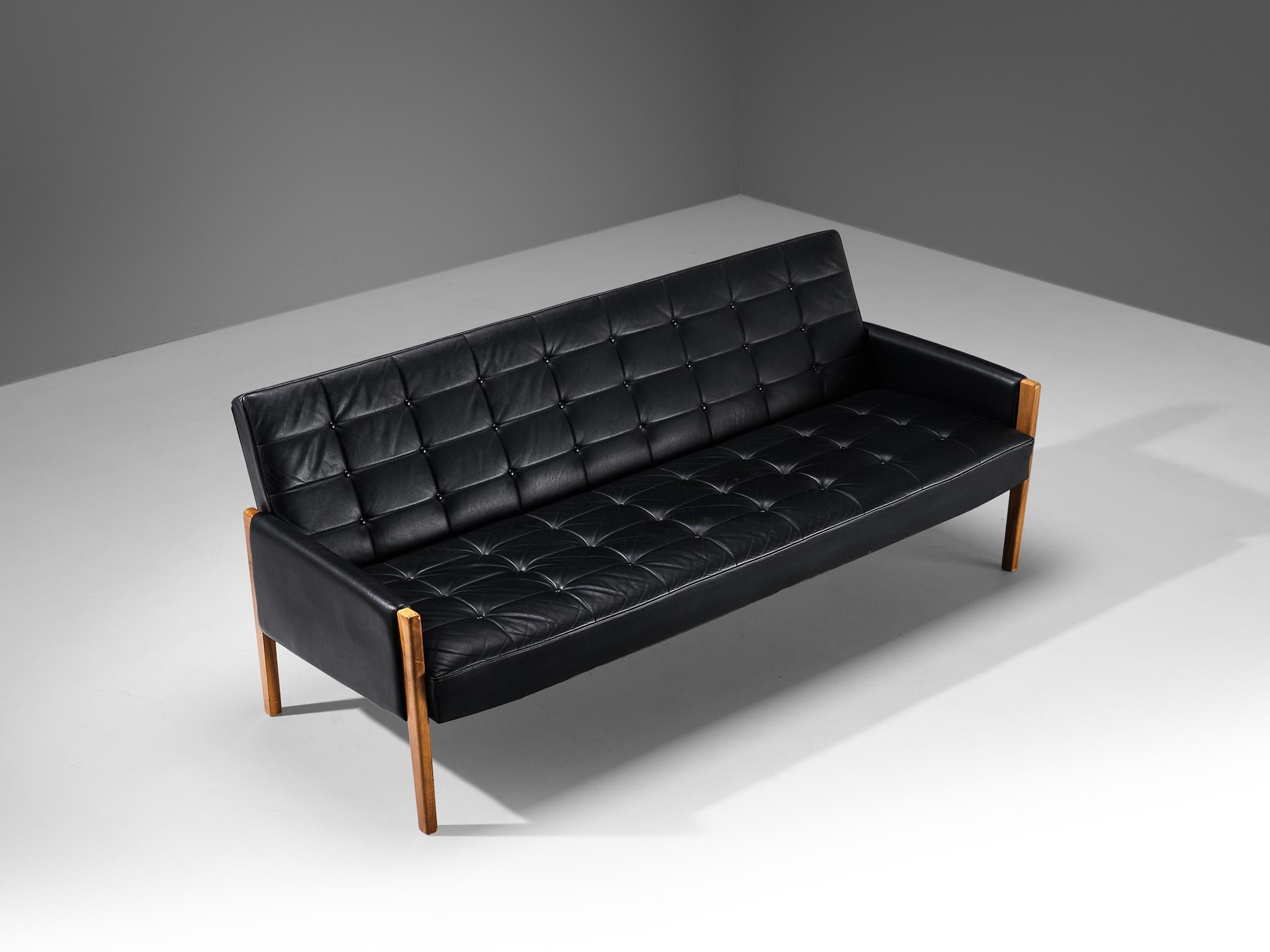 Sofa, leatherette, walnut, Scandinavia, 1960s

This Scandinavian Modern sofa is characterized by a simplistic, natural and timeless aesthetics. The design features a solid construction of clear lines and angular shapes. The most distinctive feature