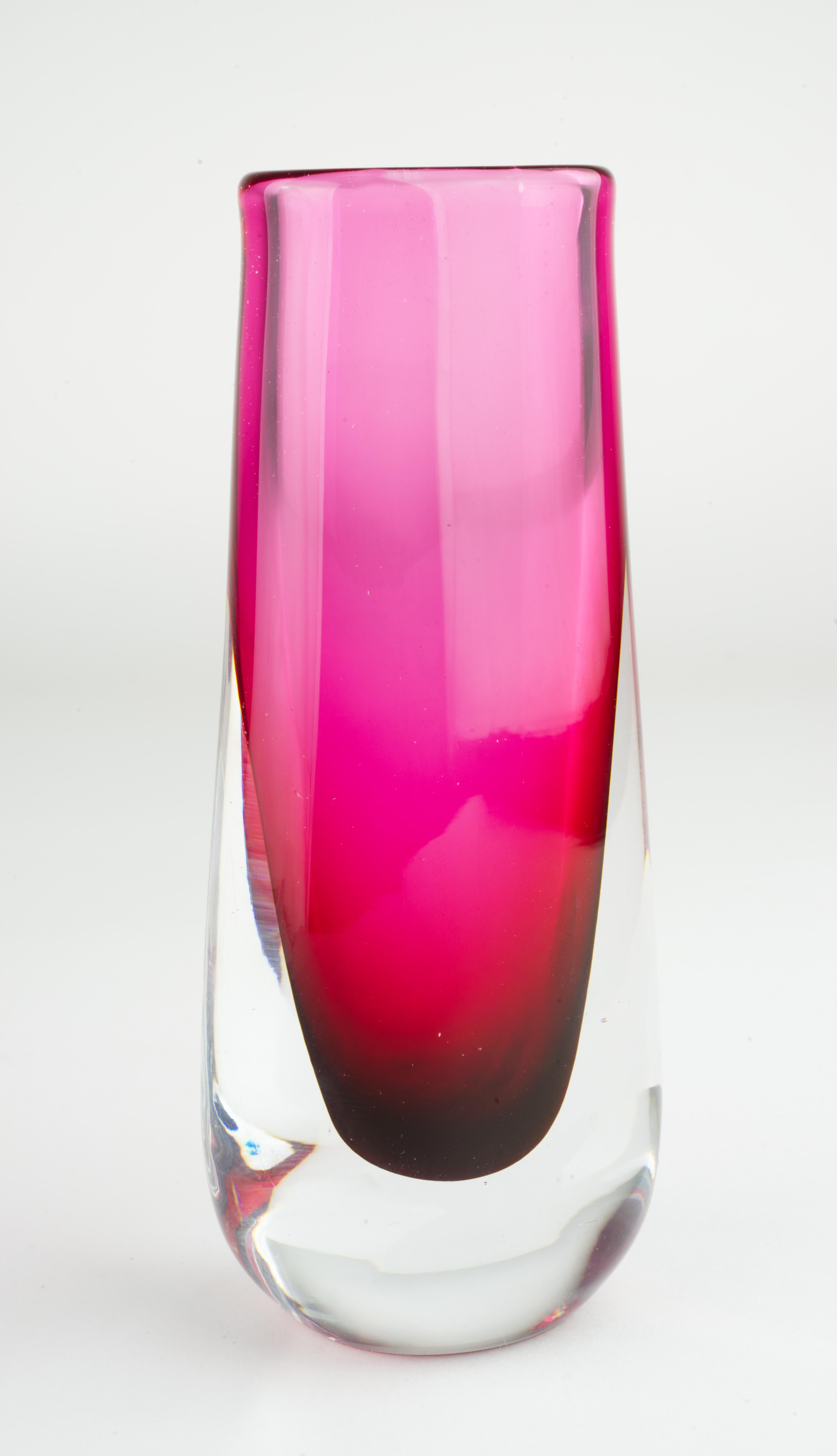  Scandinavian Mid Century Modern art glass bud vase is made in sommerso technique with cranberry red top and clear glass bottom. The vase is a part of the series designed by Josef Schott (1915 - 2009) for Smalandshyttan glassworks, that operated in