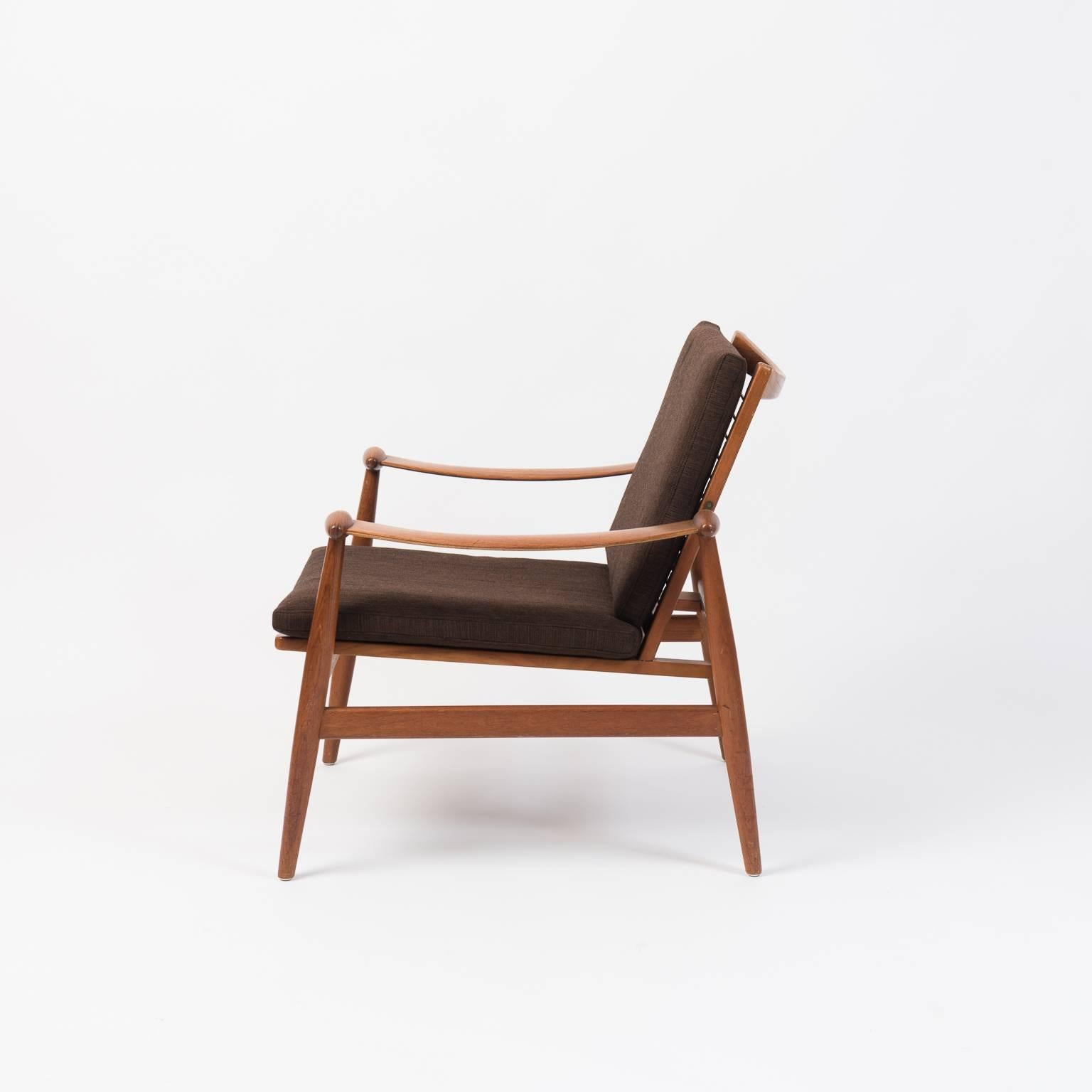 Easy chair designed by Finn Juhl for France & Daverkosen designed during the 1950s. Original condition with a light natural patina. The chair is a great example of the Mid-Century Modern and Scandinavian Modern styles. The teak is in good vintage