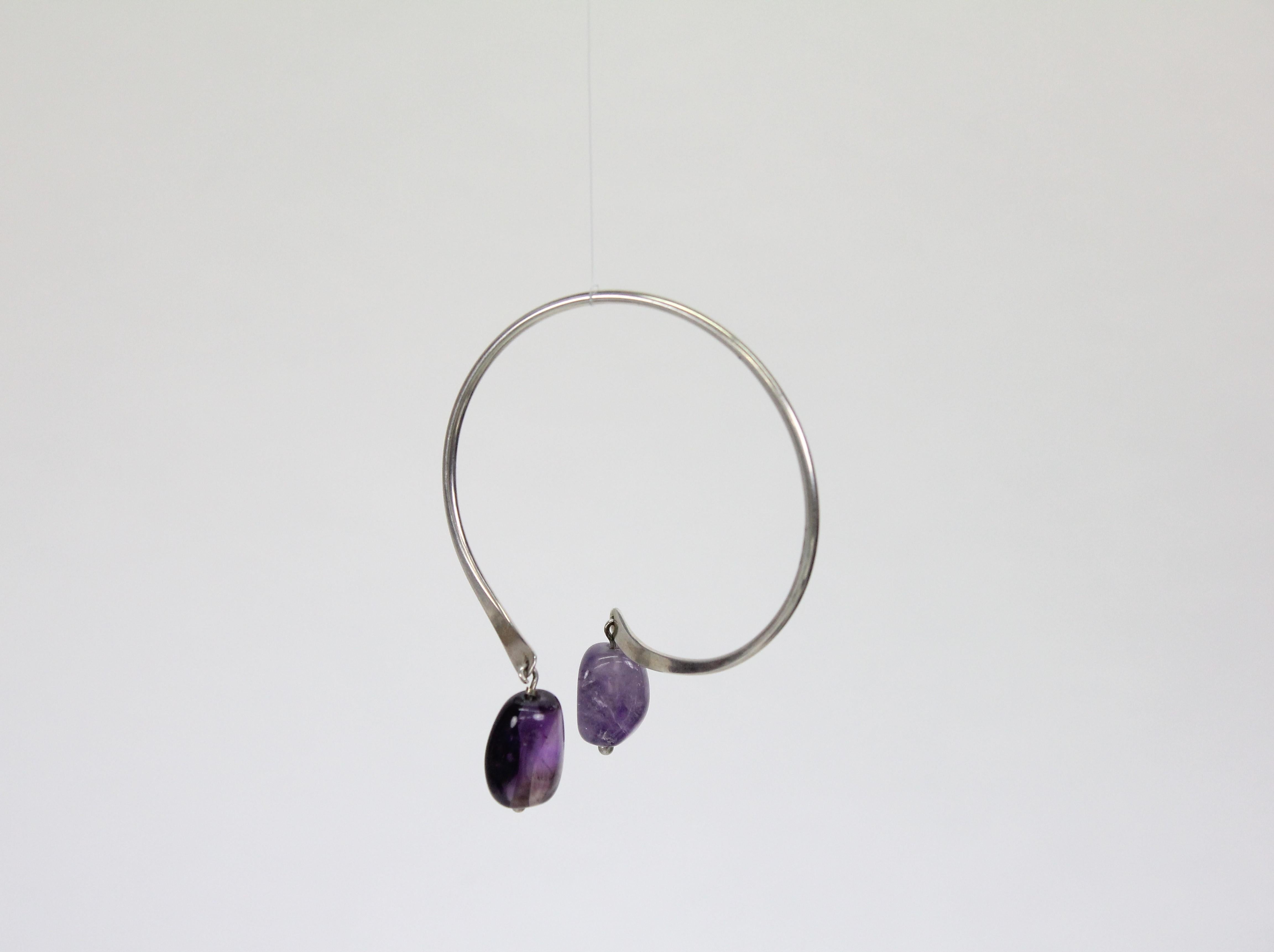 Wonderful bracelet by Swedish Modernist jeweler Borgila in Stockholm.
Sterling silver and with two hanging tumbled amethysts. 
This bracelet can be worn in different ways, see images. 

Fully marked with Swedish silver stamps.
Diameter circa 6.5cm