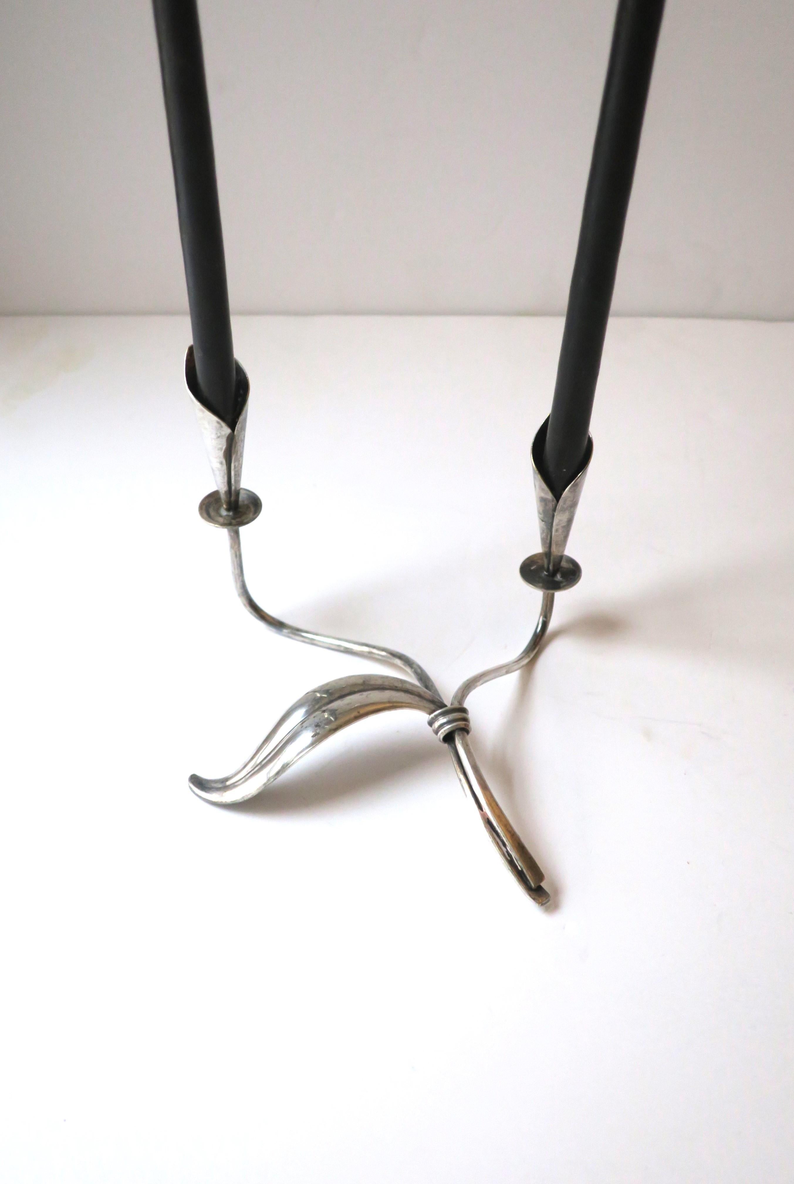 A beautiful Danish / Scandinavian Modern / Organic Modern sterling silver plate candlestick or candelabra holder attributed to designer Hans Jensen, circa mid-20th century, Denmark. Holder has two stems with modern Calla Lilly flower sconces, small
