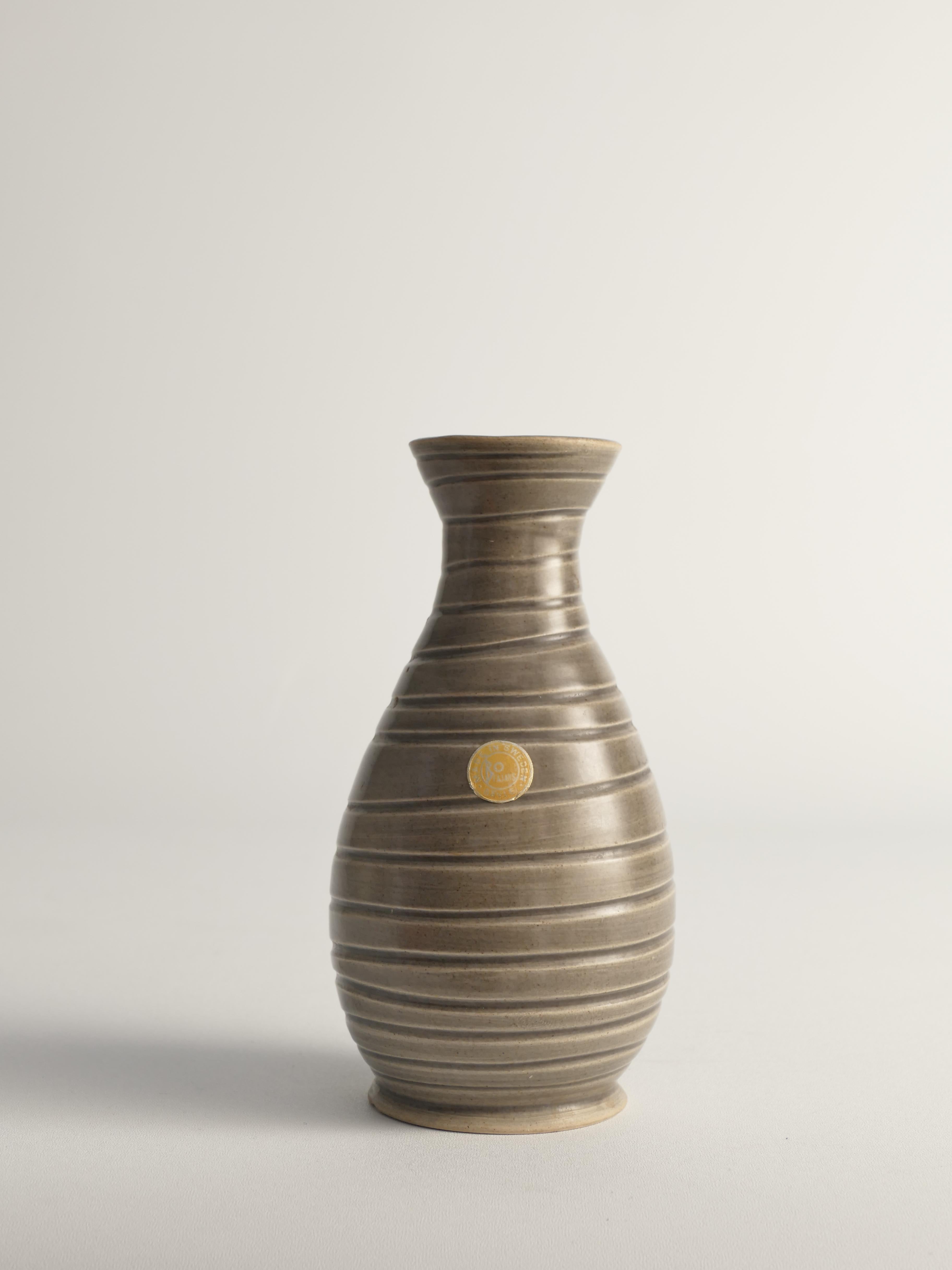 This scandinavian modern stoneware vase attributed to Ewald Dahlskog for Bo Fajans is extremely elegant. It is labeled and deep stamped 