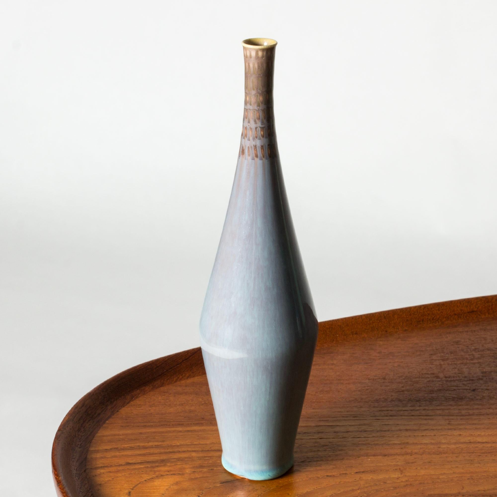 Unique stoneware vase by Stig Lindberg, slender and tall with an embossed graphic pattern around the rim. Beautiful glossy sky blue glaze.
