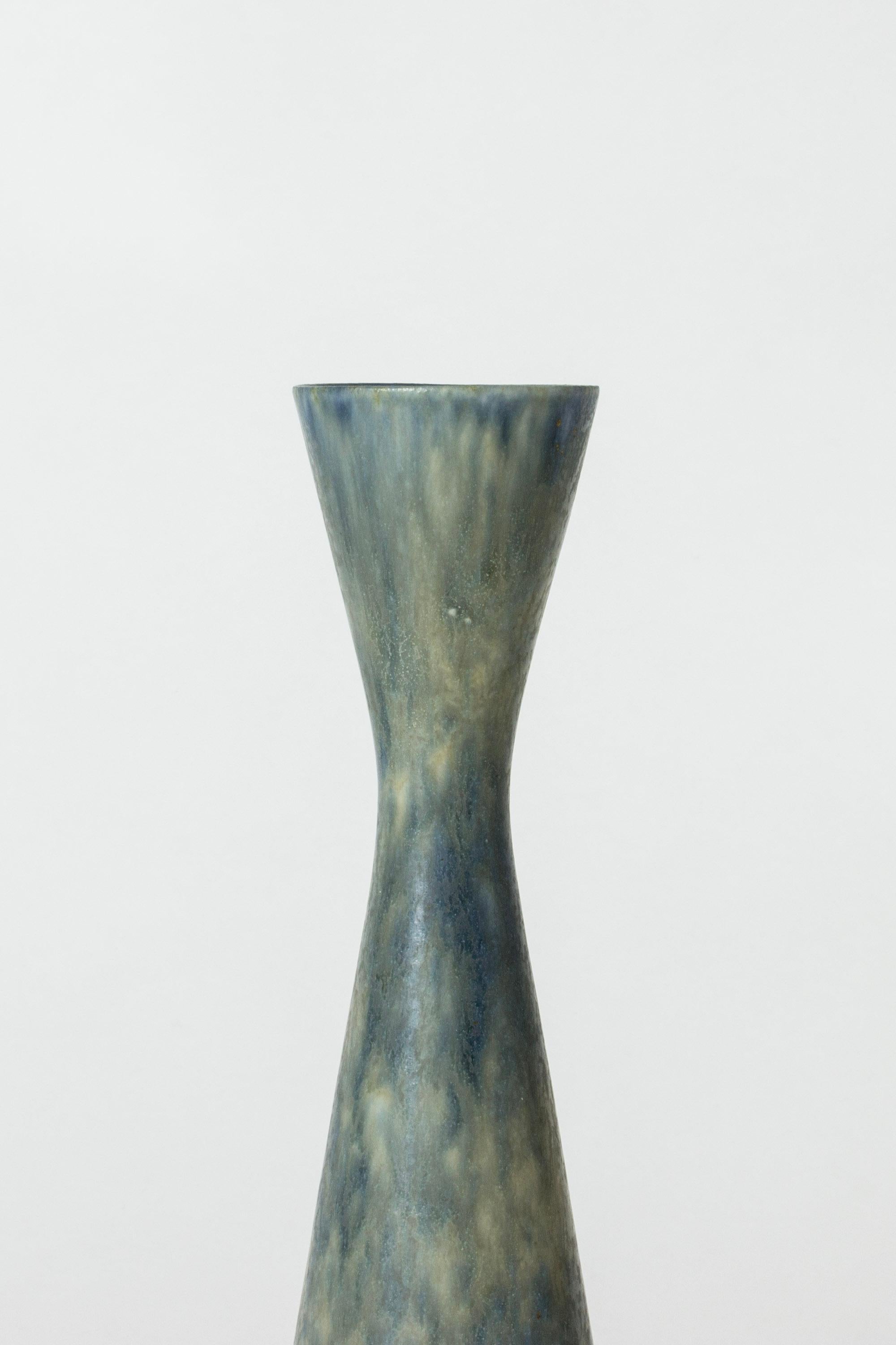 Cool stoneware vase by Carl-Harry Stålhane in a sleek form. Thick blue glazes blends with yellow tones.

Carl-Harry Stålhane was one of the stars among Swedish ceramic artists during the 1950s, 1960s and 1970s, whose designs are just as highly