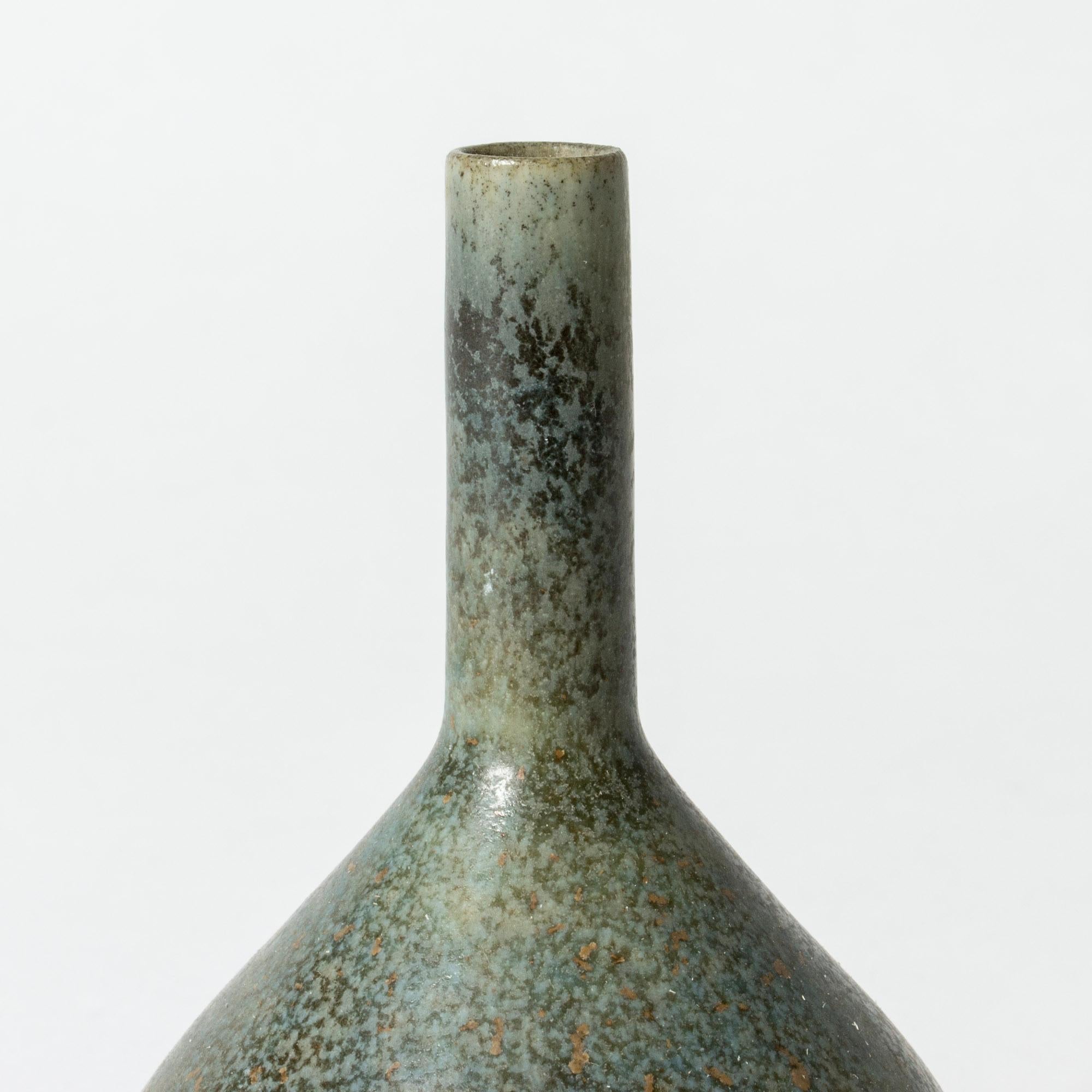 Miniature stoneware vase by Carl-Harry Stålhane with an angular plump body contrasted with a straight, slender nozzle. Beautiful greyish blue glaze.

Carl-Harry Stålhane was one of the stars among Swedish ceramic artists during the 1950s, 1960s