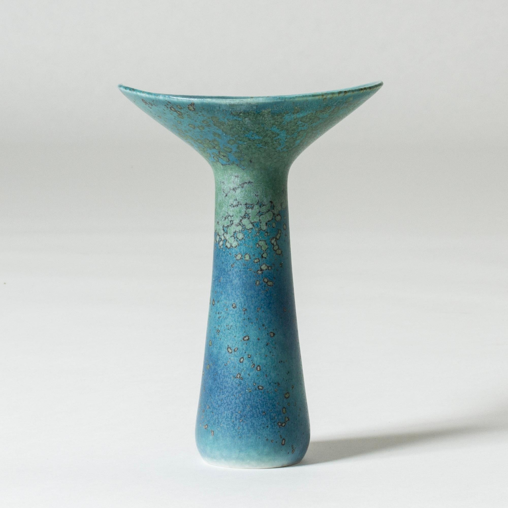 Stoneware vase by Carl-Harry Stålhane in an beautiful form with a wide-rimmed mouth and slender body. Striking glaze in ocean blue and turquoise tones.

Carl-Harry Stålhane was one of the stars among Swedish ceramic artists during the 1950s, 1960s