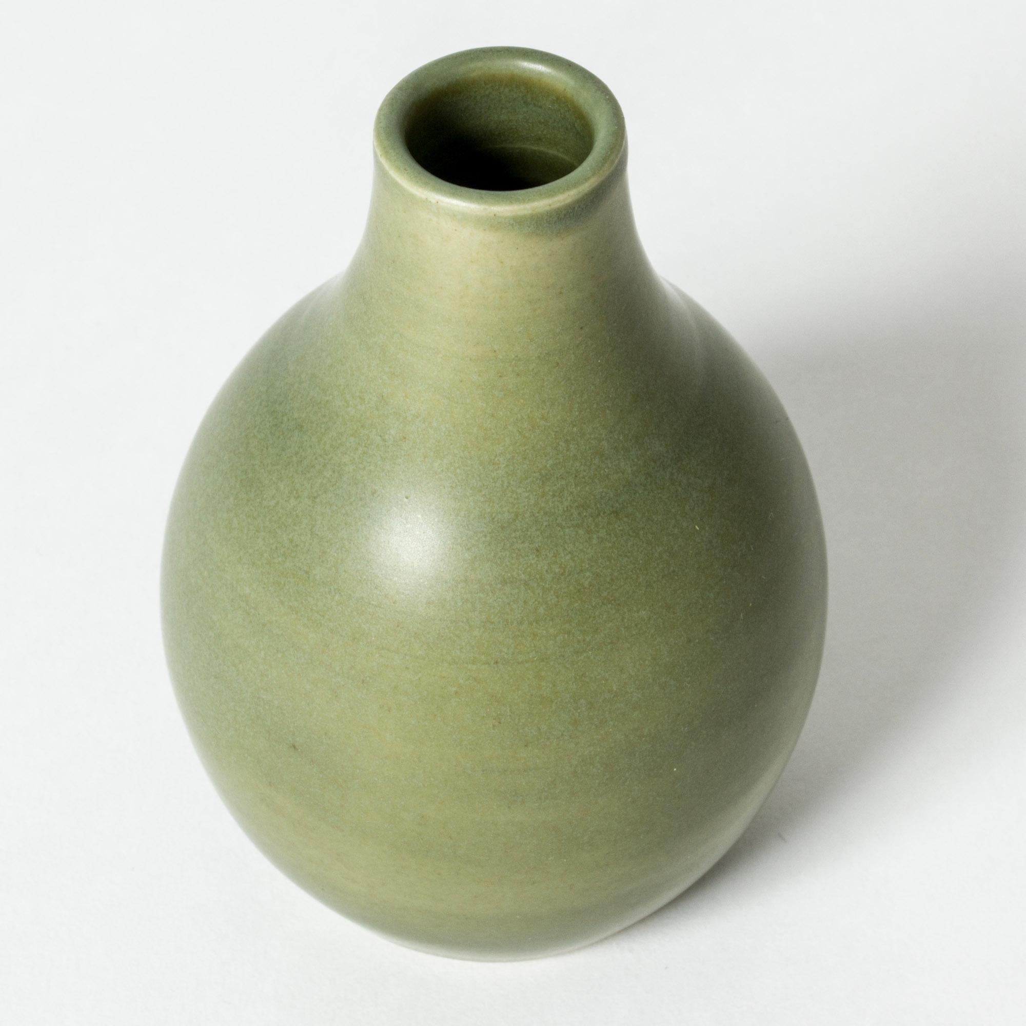 Beautiful stoneware vase by Eric and Ingrid Triller, in an appealing, streamlined shape. Smooth, moss green glaze.

Fleeing World War II, German potters Eric and Ingrid Triller settled in the industrial village Tobo and started making their Bauhaus