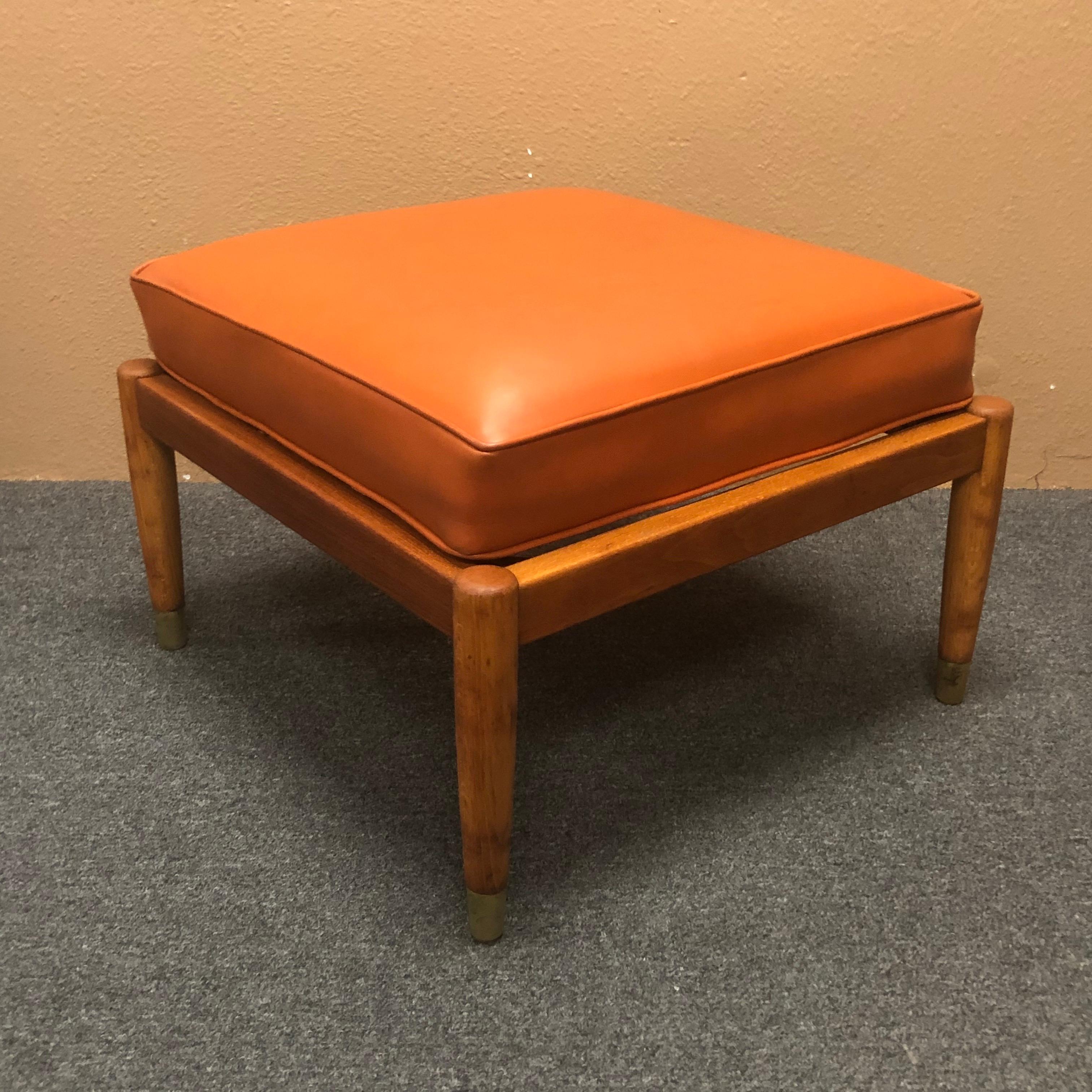 Versatile Scandinavian modern stool / ottoman / bench with floating butterscotch colored naugahyde cushion, circa 1950s. The piece has a solid teak frame with brass capped legs and is quite solid and sturdy. The bases measures: 22.5