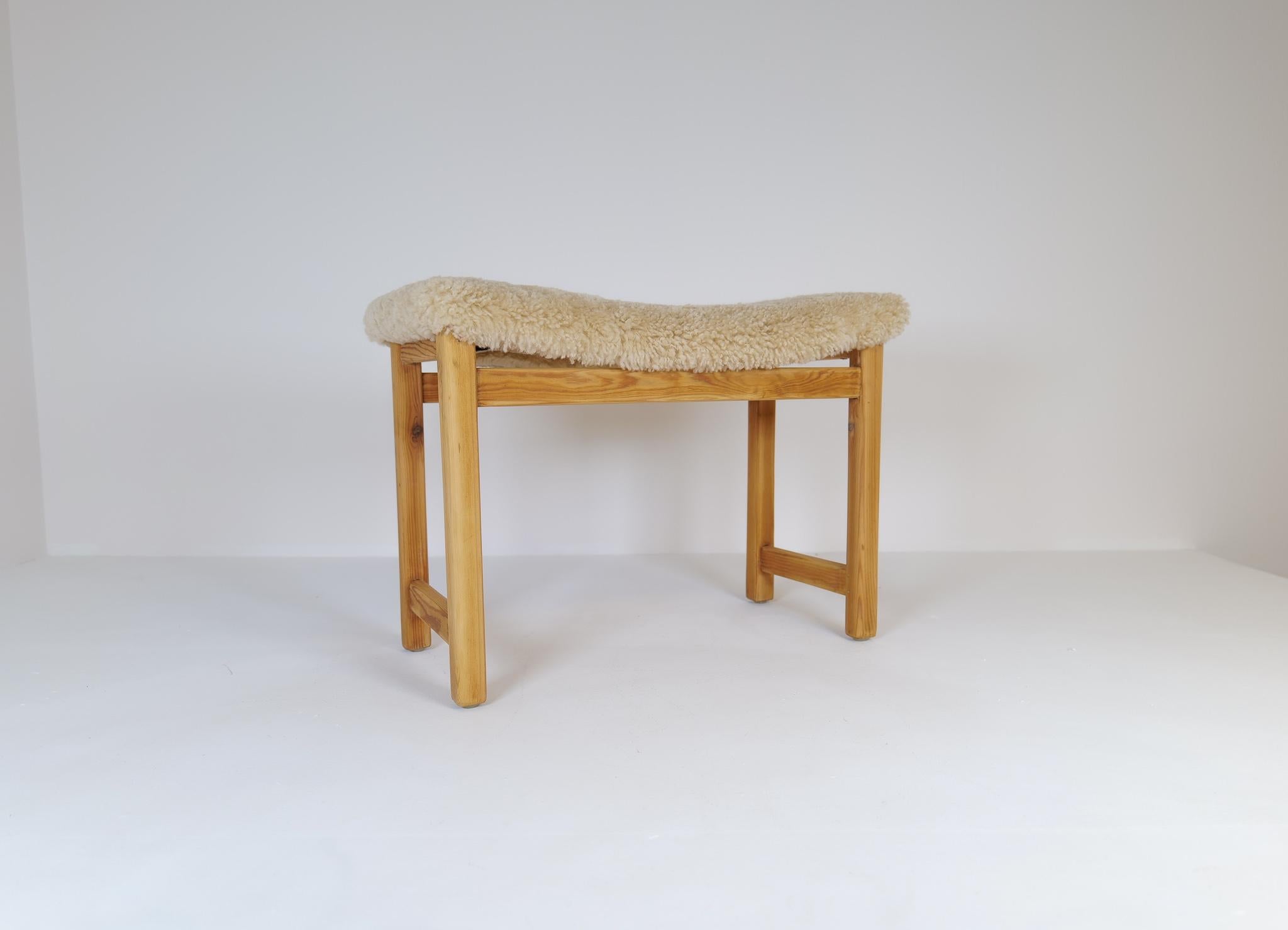 A stool made in Pine with newly upholstery in sheepskin. Natural and typical stool produced in Sweden during the 1960-1970s
This stool is a good example of the good craftsmanship and minimalistic stile to come in Scandinavian furniture. 

Good