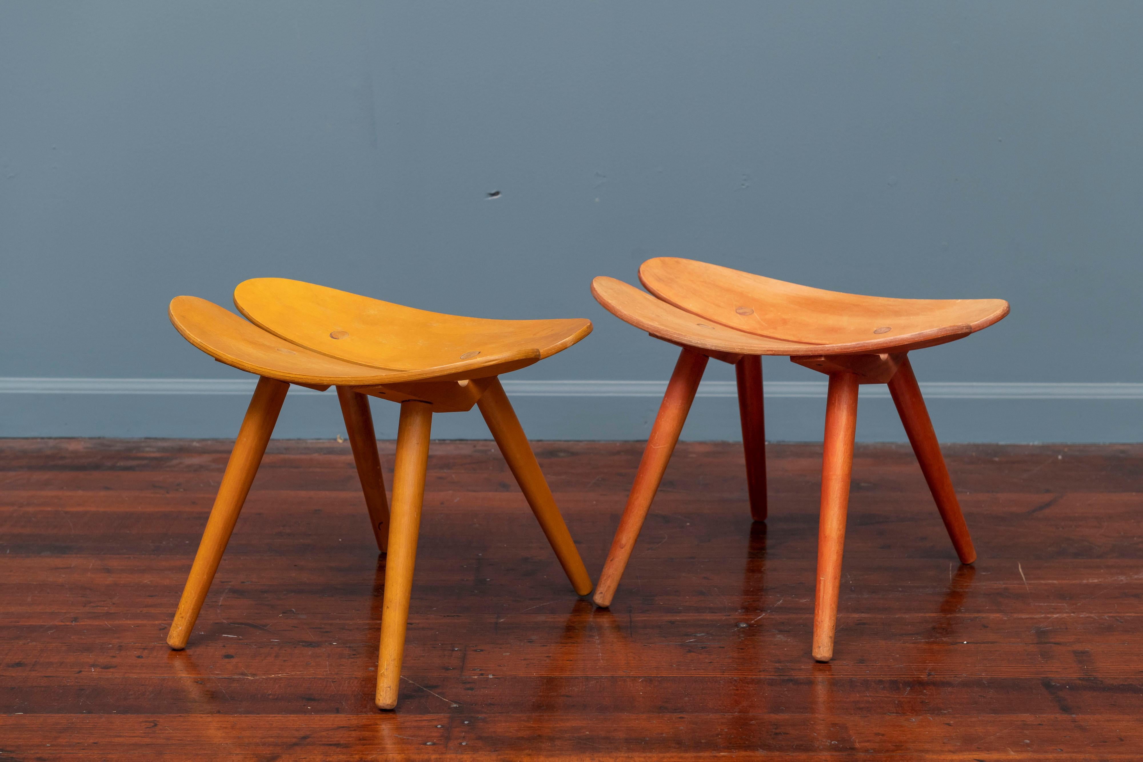 Scandinavian stools in anodized yellow and red with slight color fade consistent with age and use.