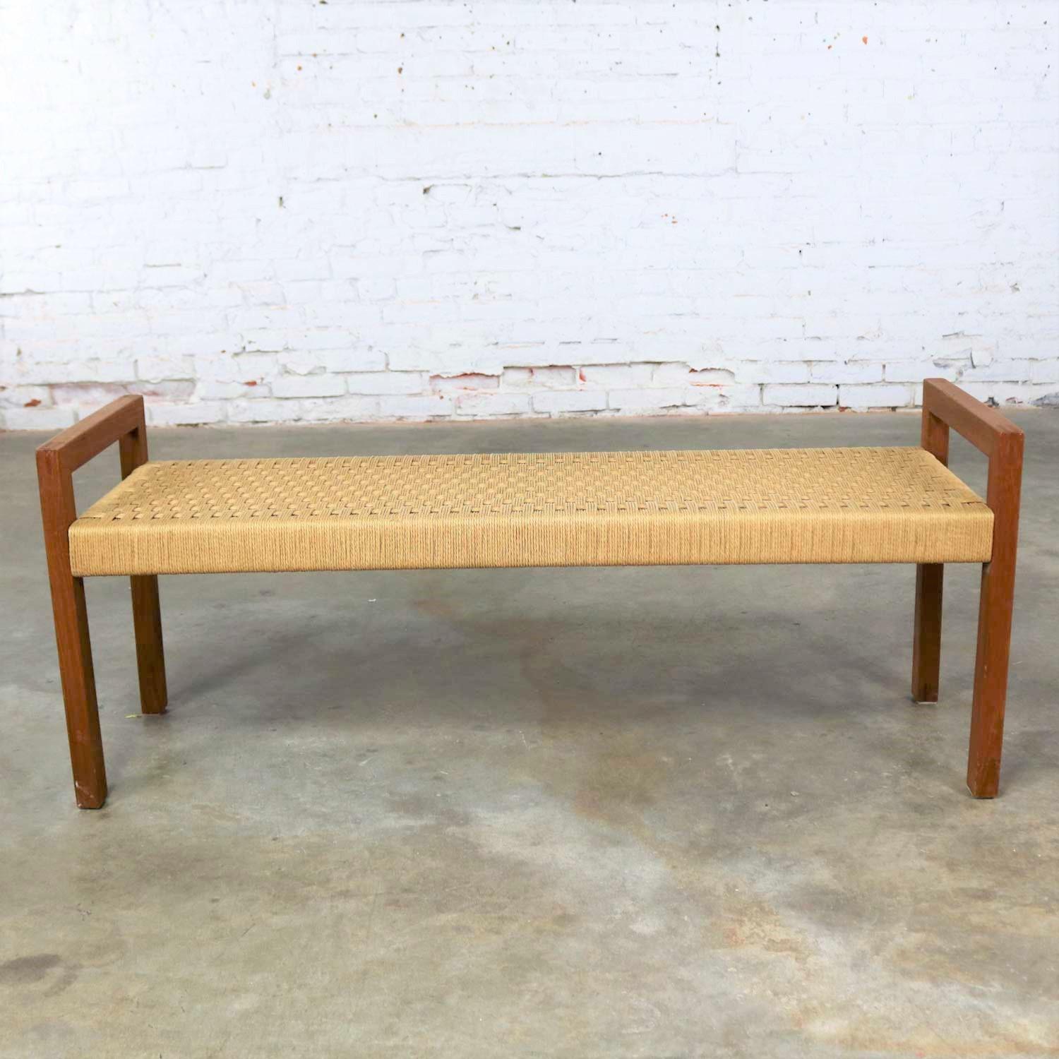 Handsome Scandinavian modern style teak bench with woven rope seat by Sun Cabinet Company. It is in wonderful condition with normal wear for its age, circa early 21st century.

Sometimes you need just the right little bench. This is it. It’s not a