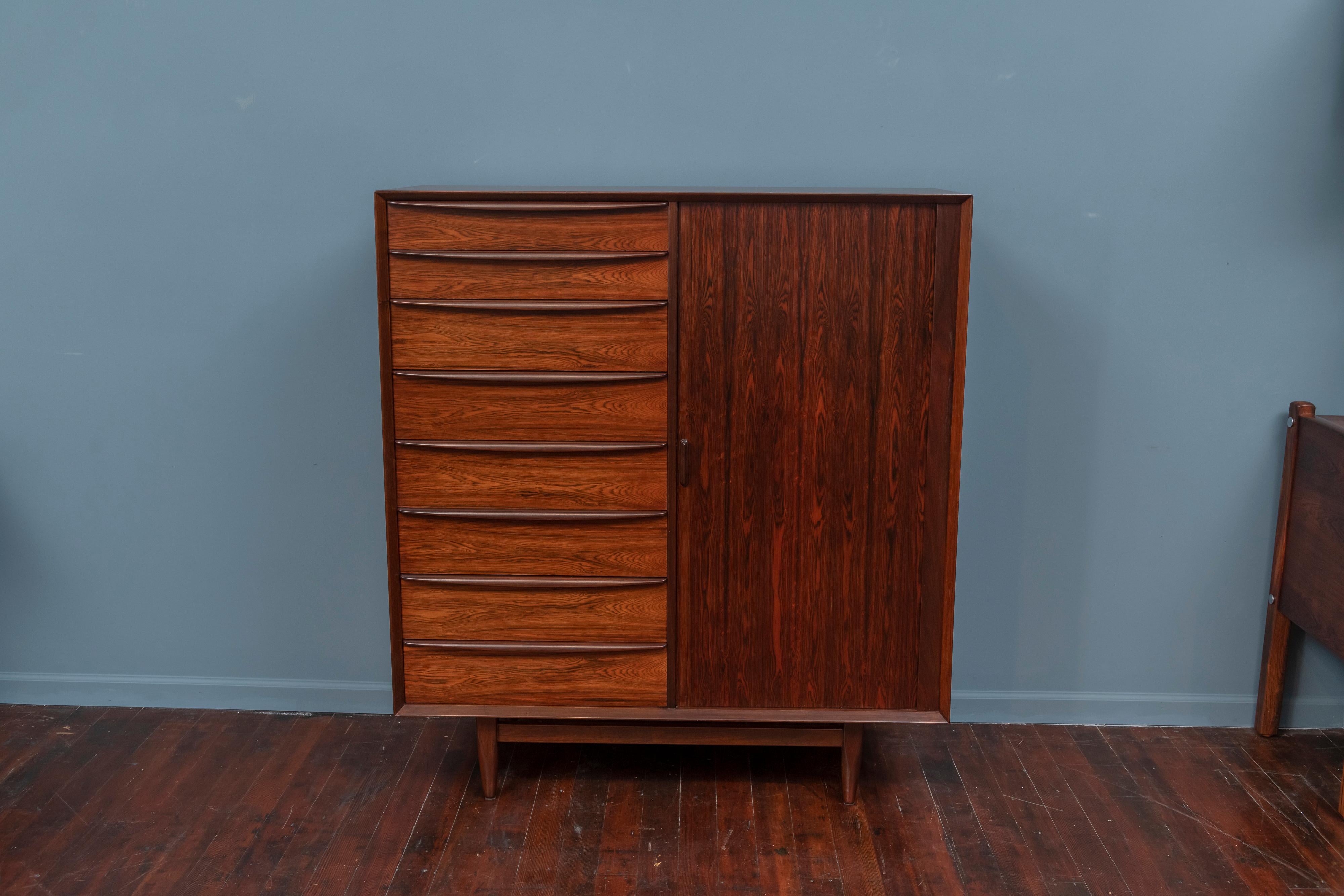 Scandinavian Modern tall chest of drawers or high boy designed by Svend Madsen for Falster Mobelfabrik, Denmark. Beautifully refinished rosewood throughout with eight drawers and nine interior drawers concealed by a tambour door, stamped.