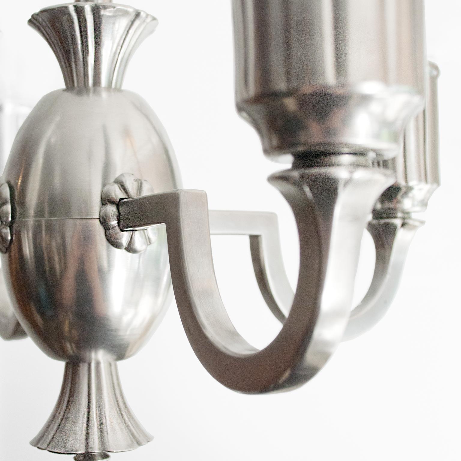 Scandinavian Modern, Swedish Grace, Art Deco 4-arm chandelier in polished and lacquered pewter. The four arms extend from an ovoid center element, each has been wired with a standard base socket for use in the USA. A modern design which features