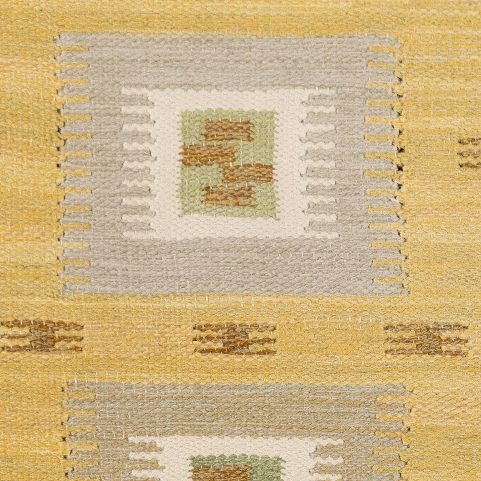 Beautiful geometric decor in Yellow, grey, green and brown tones. This rug is from Nk-textilkammare (NK-textile chamber) flat-woven Swedish rug, executed in a single interlocking tapestry technique. Signed NKT (Nk textile chamber). The department