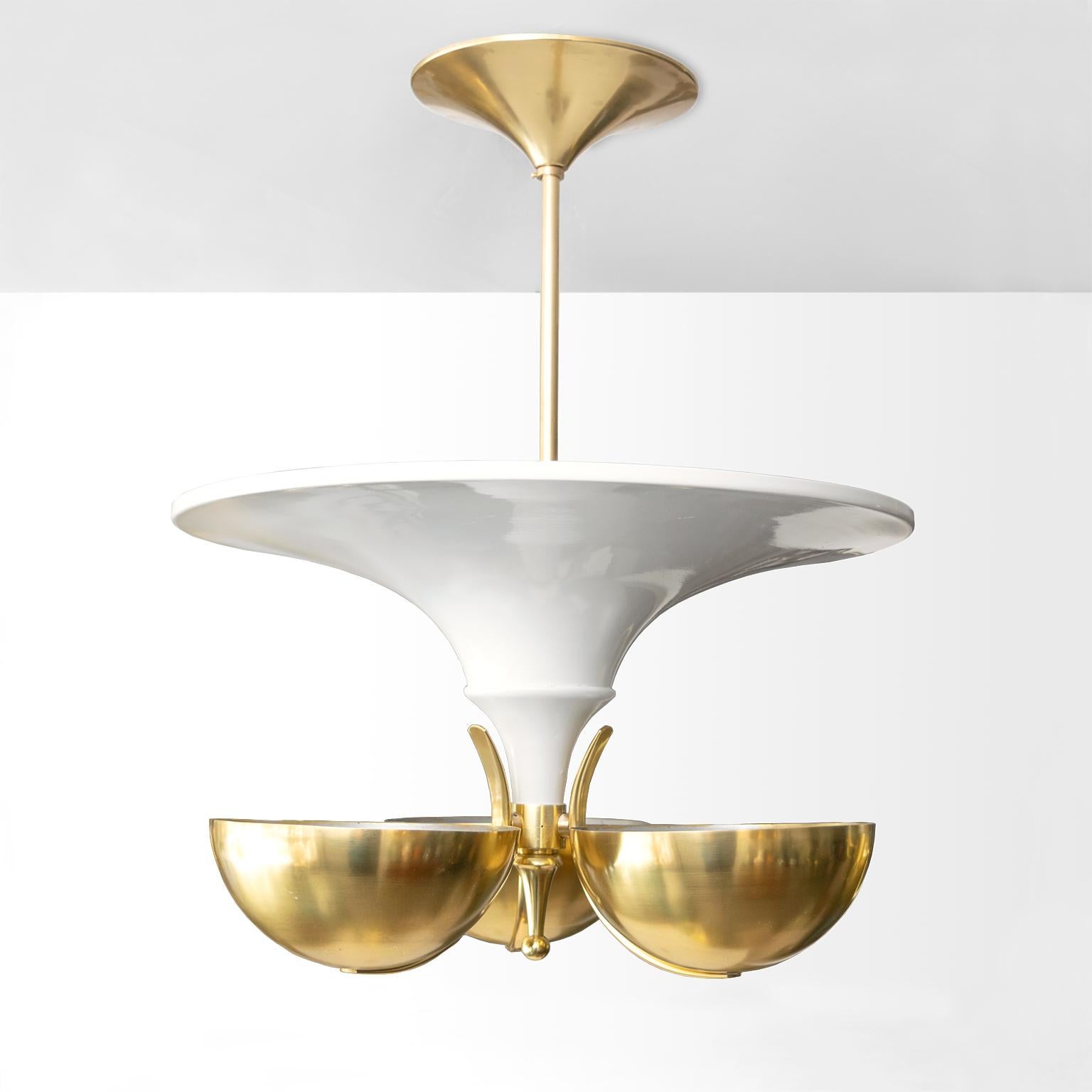 Scandinavian Modern, Swedish Art Deco chandelier with a large white lacquered reflector surrounded by 3 polished brass hemisphere shades. The reflector has 3 internal standard base sockets and the brass shades have one each. This chandelier has been