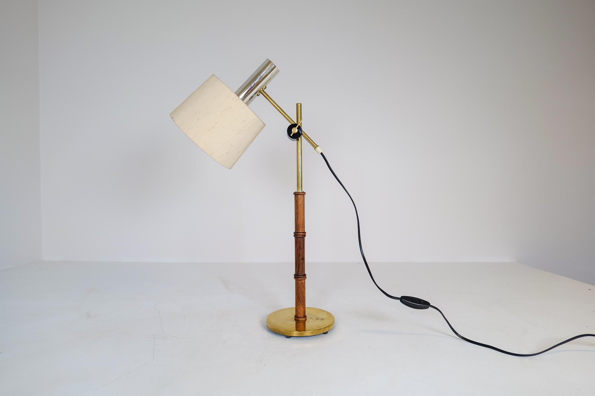This lamp was made in Sweden at Falkenbergs Belysning. It has an adjustable height and angle arm, and is made in brass, wooden steam, and cast-iron base.

Good working condition with some dents on the foot and scratches on the