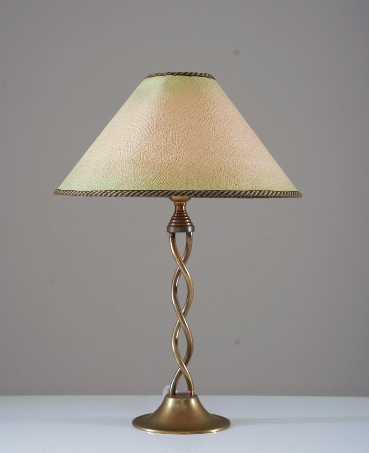 Swedish modern table lamp in brass, most likely produced in Sweden, 1930s.

Condition: Very good condition. The lamps come with a matching vintage shade from the same era.
