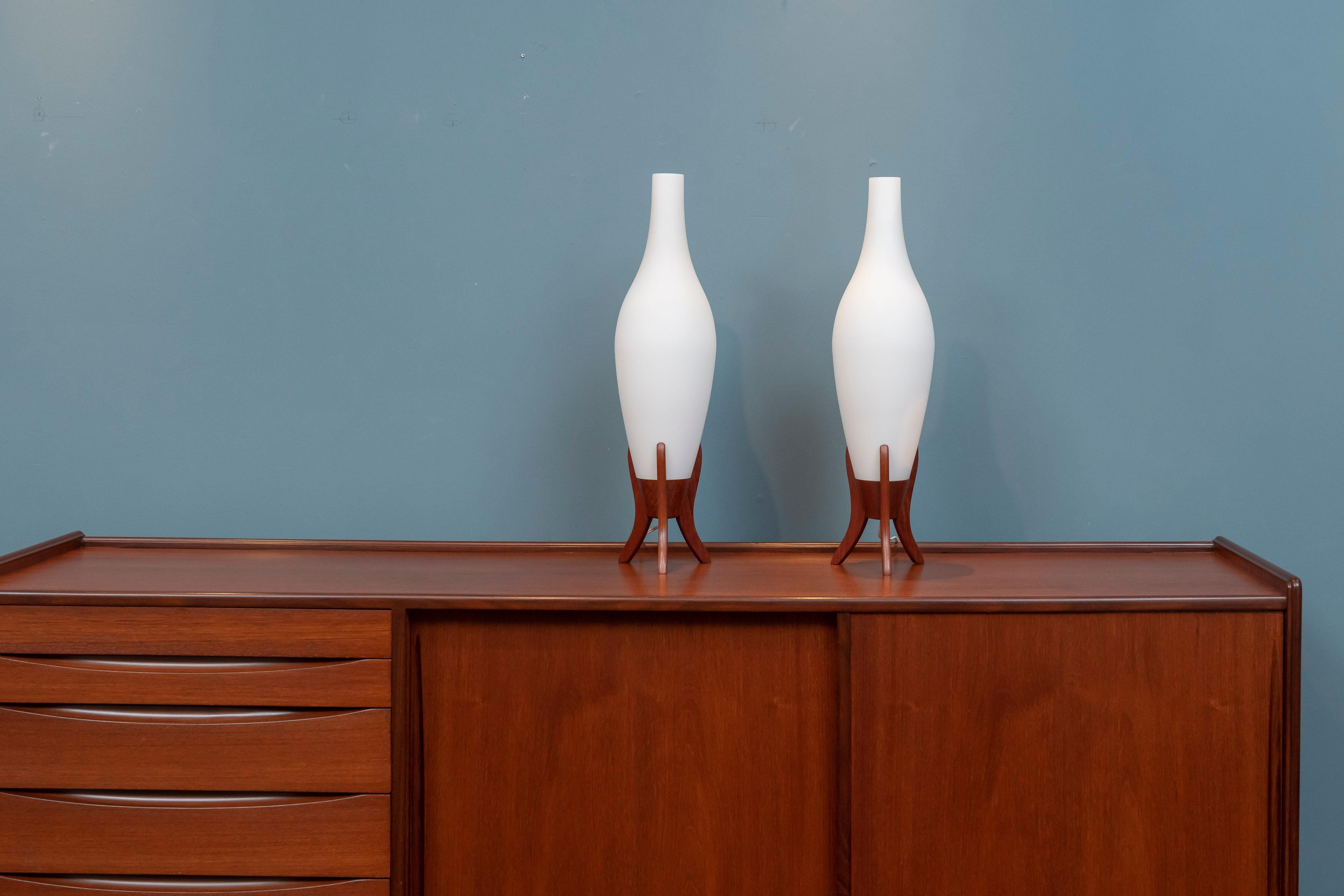 Scandinavian Modern frosted glass and teak table lamps, Sweden. Tall and elegant design lamps that put out a wonderful soft glowing light in very good original condition.