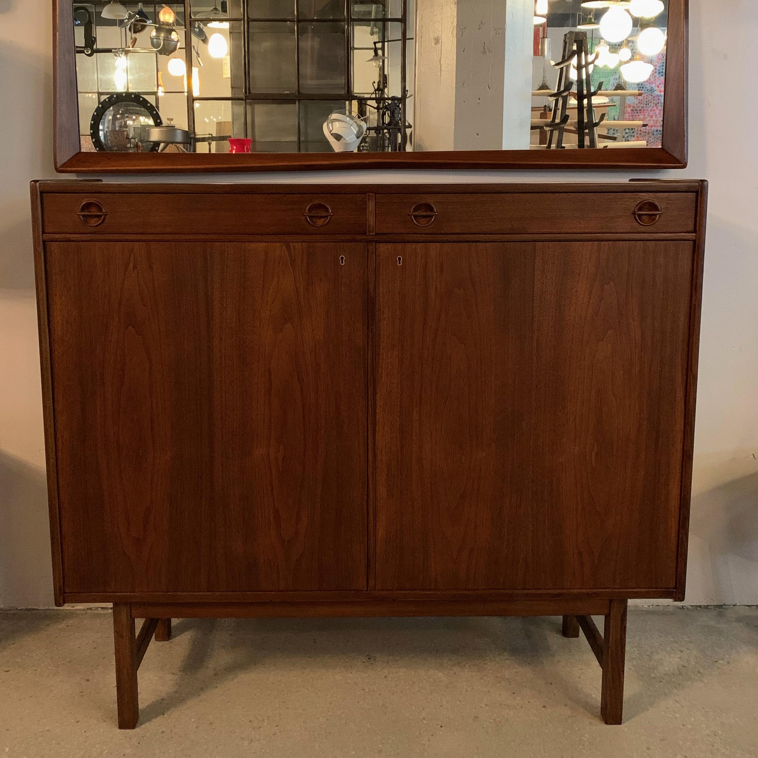 Tall, Danish modern, sideboard cabinet is a great size at 4ft wide and 17 inches deep. The interior bottom sections measure 26.5 height x 23 width inches each with adjustable interior shelves.