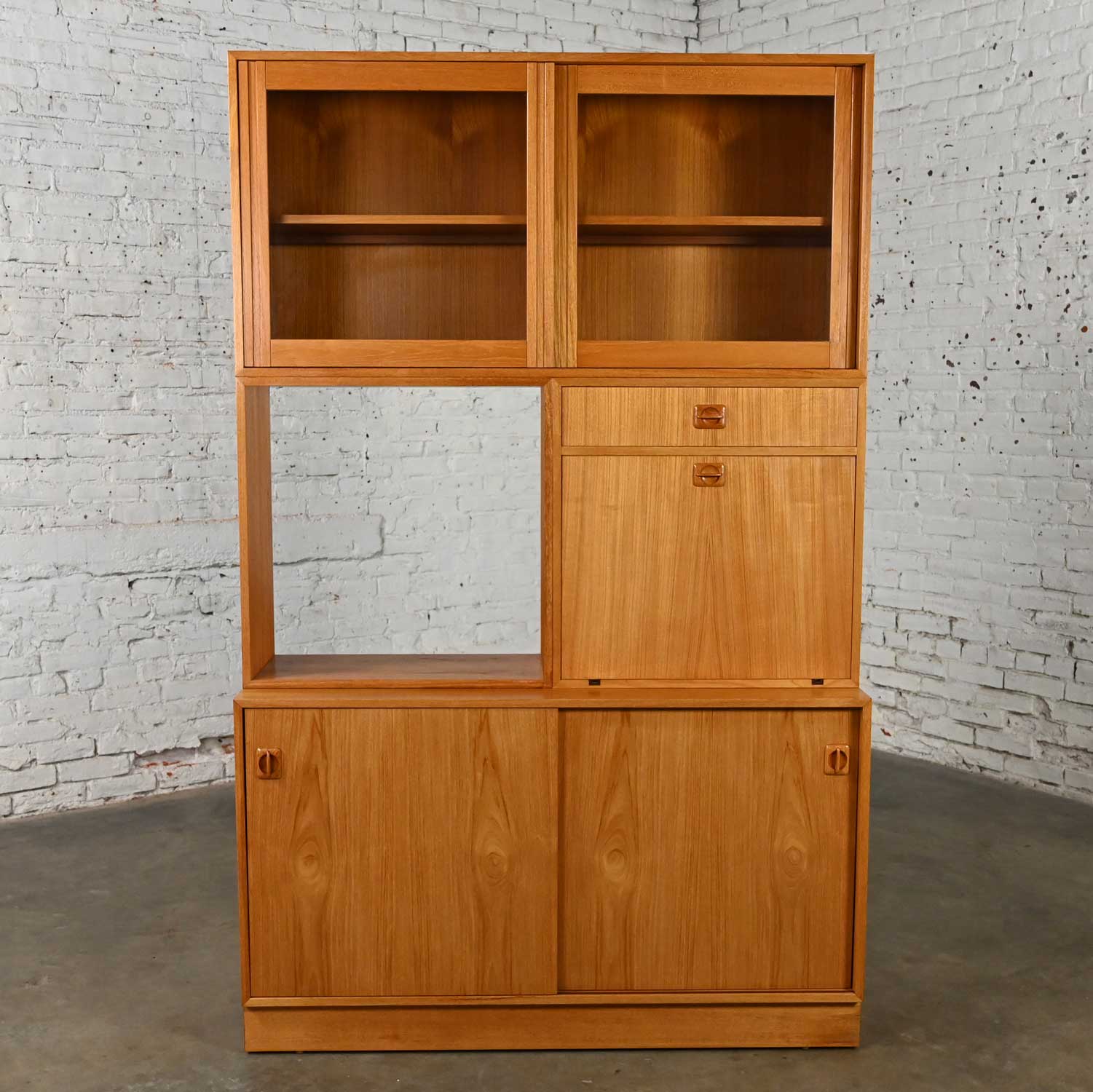 Handsome vintage Scandinavian Modern teak 4-part triple stacked display cabinet, or secretary, or dry bar made in Denmark. Beautiful condition, keeping in mind that this is vintage and not new so will have signs of use and wear. No outstanding flaws