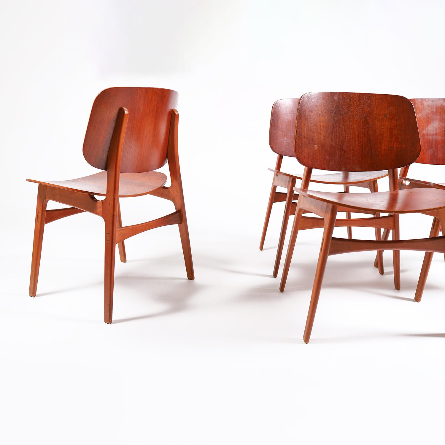 A set of four sculptural teak and beech dining chairs, designed by Borge Mogensen, for Soberg Mobler (model 155). Beechwood frame with teak seat and backrest. 

Professional, skilled furniture restoration is an integral part of what we do every