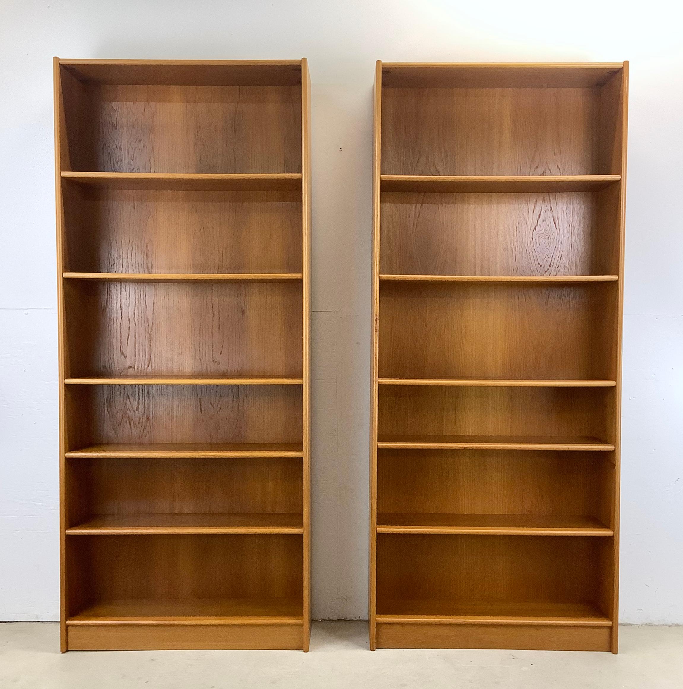 Elevate your home with this striking pair of tall vintage bookcases, echoing the renowned Danish modern design of Jesper Furniture. Perfectly sized for extra storage and versatility, these bookcases feature adjustable shelves, allowing you to