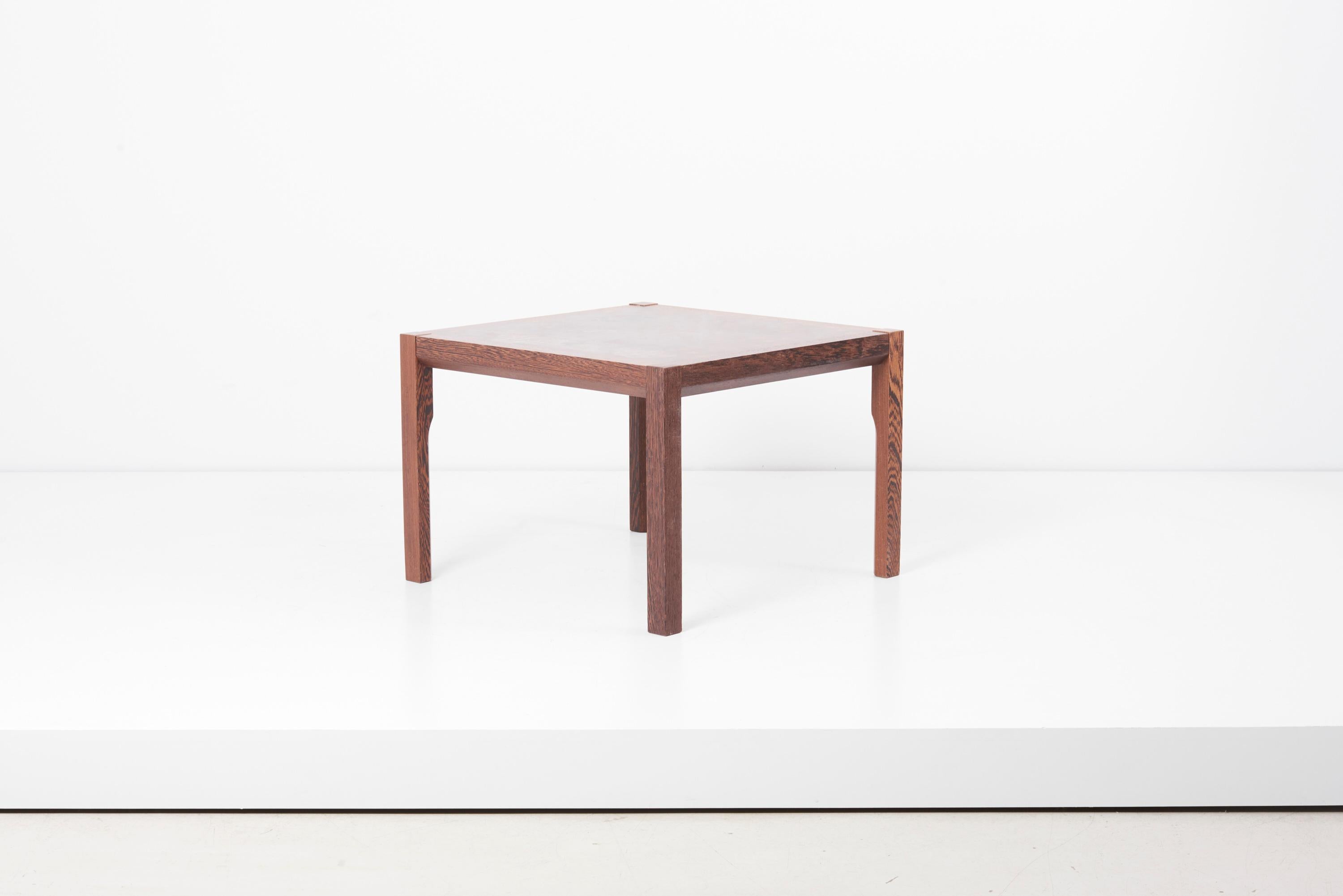 Wooden square coffee table, designed by architect Gorm Lindum and manufactured by Tranekær in Denmark. Bitmap structured table top, made of cubical solid pieces of teak combined to create an interesting structure and pattern. Unique and with serial