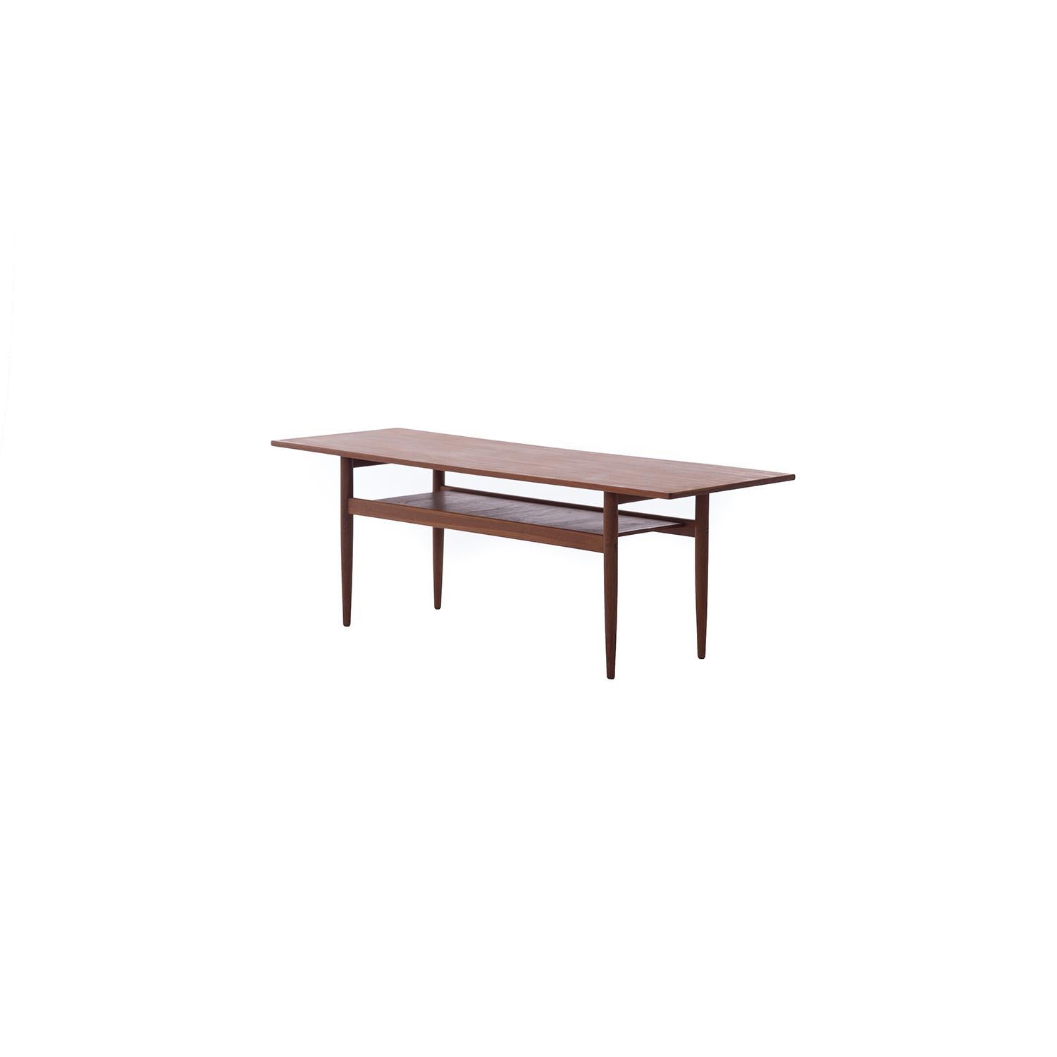 Simple clean lines make this table an easy addition to any seating ensemble. Higher top surface then your average mid-century coffee table. The table has small edge detail, shelf grain runs in opposition to grain of table. 

Professional, skilled