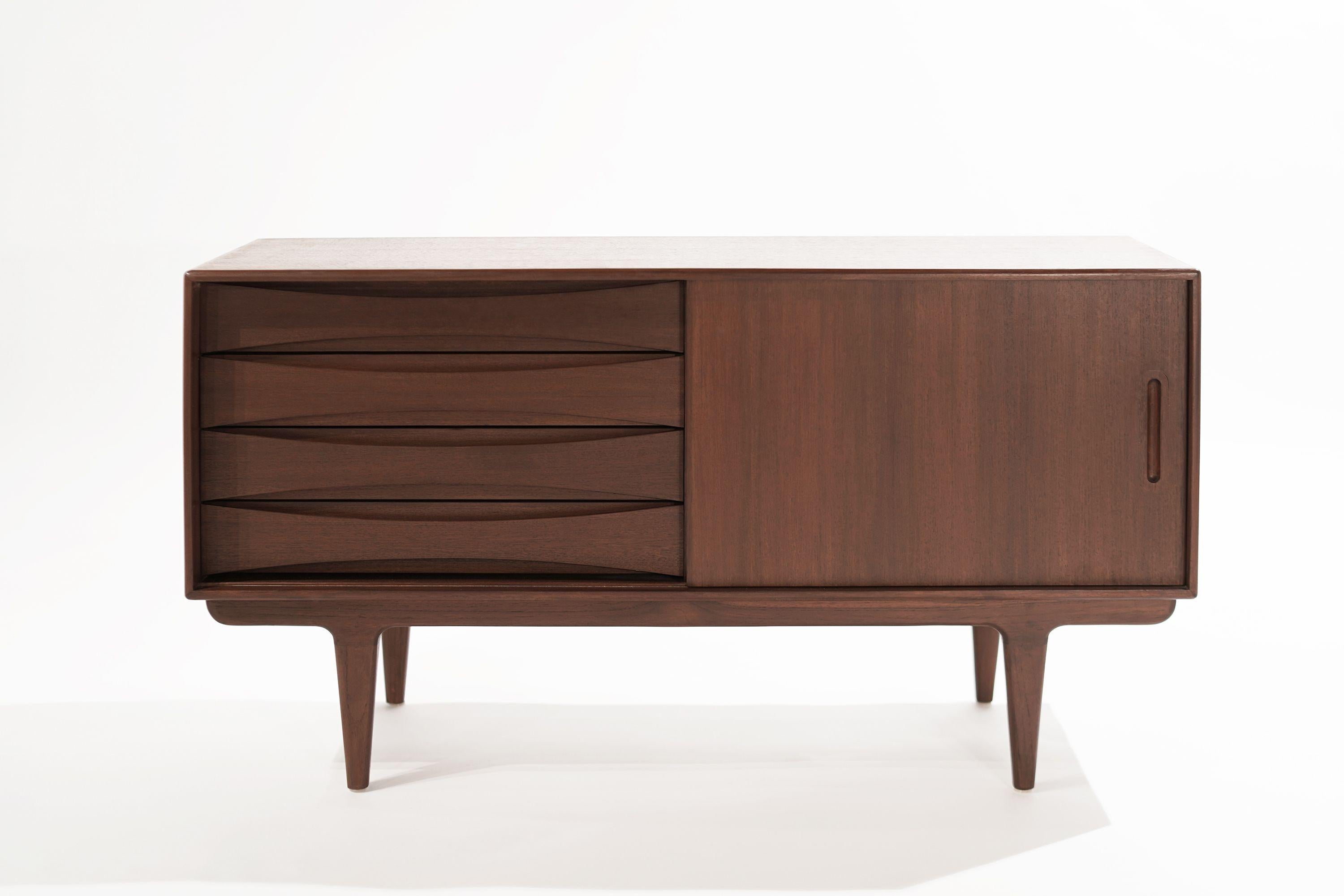 A credenza or sideboard original from Denmark, circa 1950s. Executed in teak, sliding doors open up to reveal shelving, the three drawers provide ample storage capacity.

Other designers from this period include Finn Juhl, Vladimir Kagan, Hans