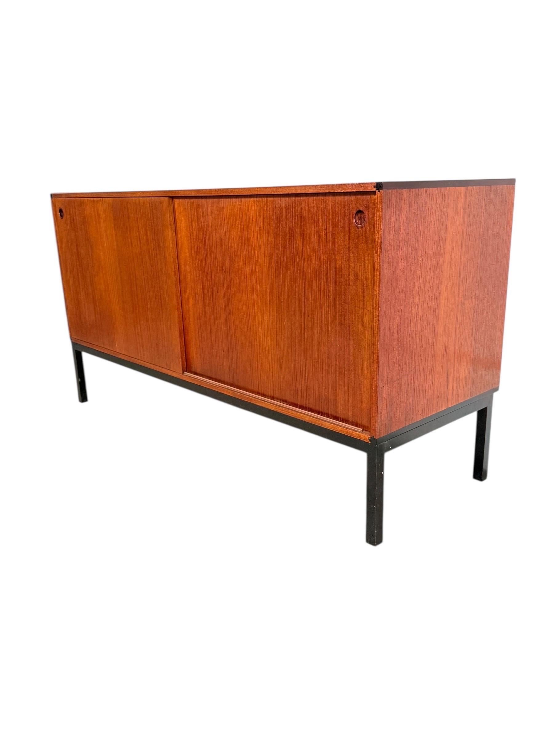 Scandinavian Modern Teak Credenza by Hans Hove and Palle Petersen for Christian Linneberg Møbler

Beautiful Danish teak credenza with clean sliding doors and classic round finger pulls. The piece sits on a black steel square tube frame that gives it