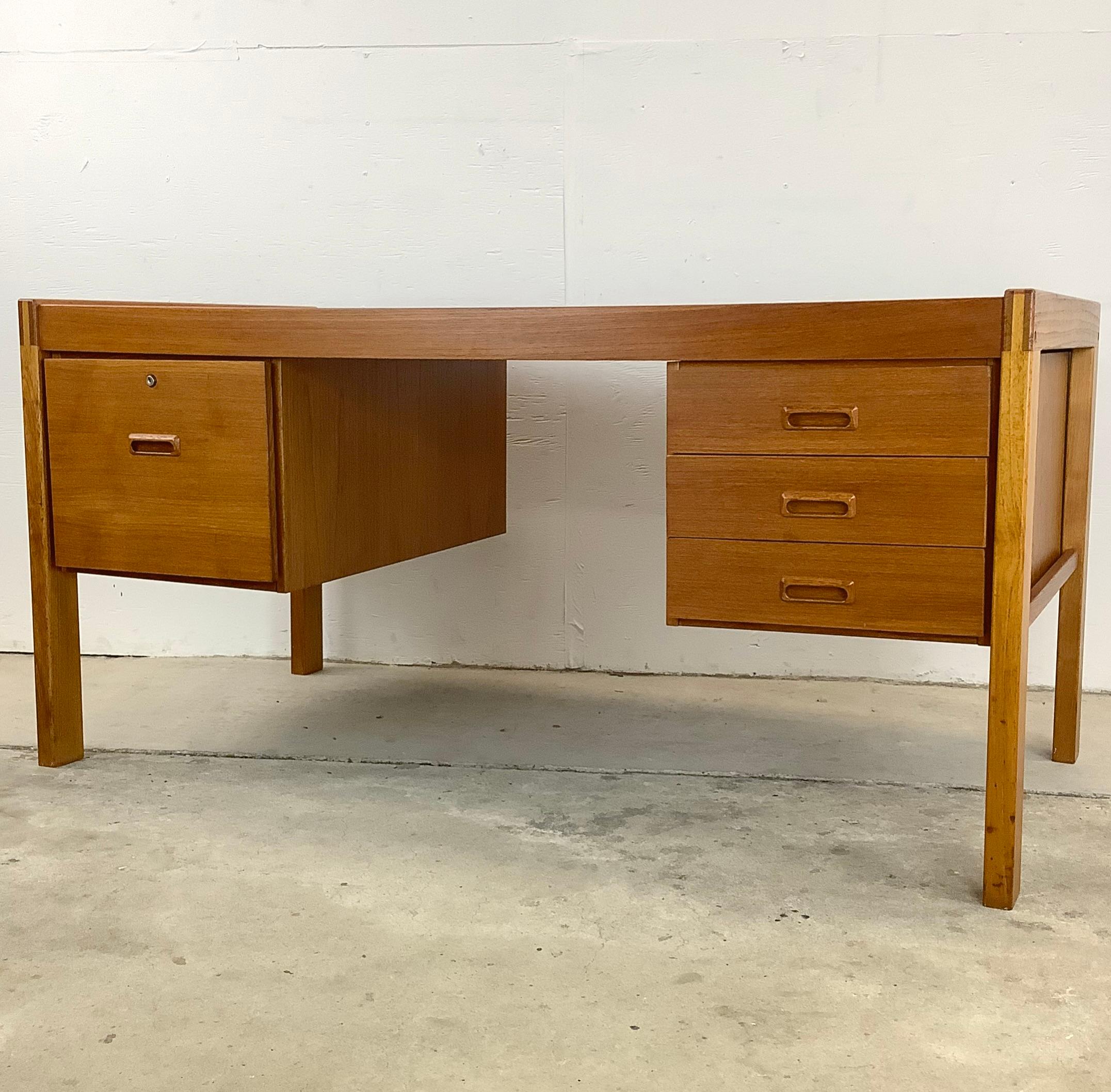 Discover a desk that beautifully combines form and function with this Danish Modern Teak writing desk. This piece is a tribute to iconic Scandinavian design and the enduring appeal of it's vintage teak finish. Imagine this desk in your workspace,