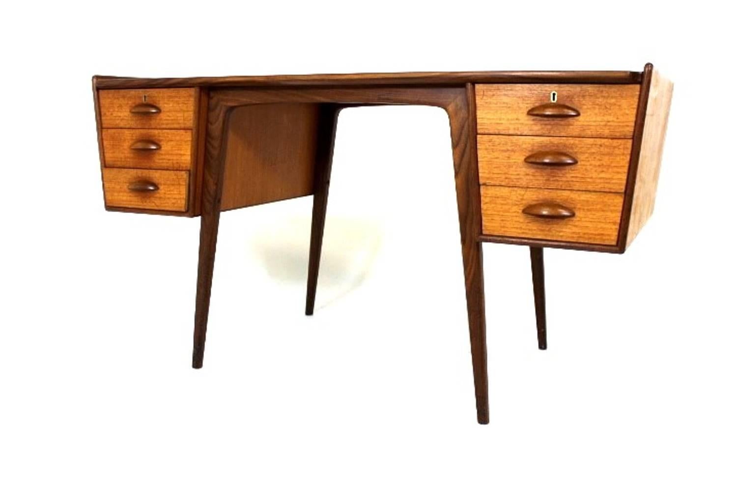 Desk in teak with six drawers on tapered legs, edging to top and freestanding. Pl. Uddebo design by Svante Skogh for AB Möbelfabriken Balder, Sweden.