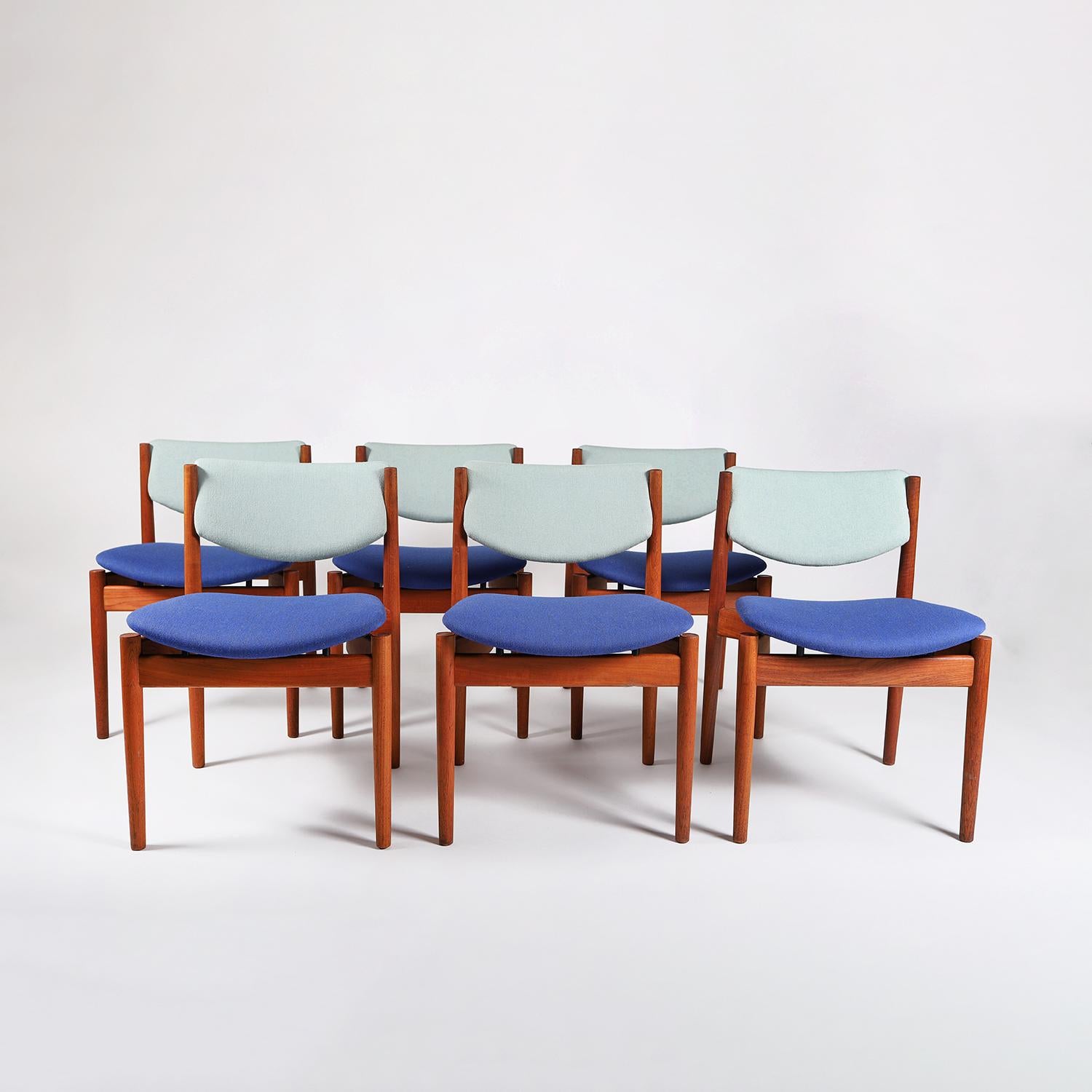 A set of six vintage original Scandinavian Modern Classic dining chairs designed by Finn Juhl for France & Son. Old growth teak frames with turned legs and crescent shaped side rails. New wool upholstery is 'Watercolor' by Kjellerup, inspired by