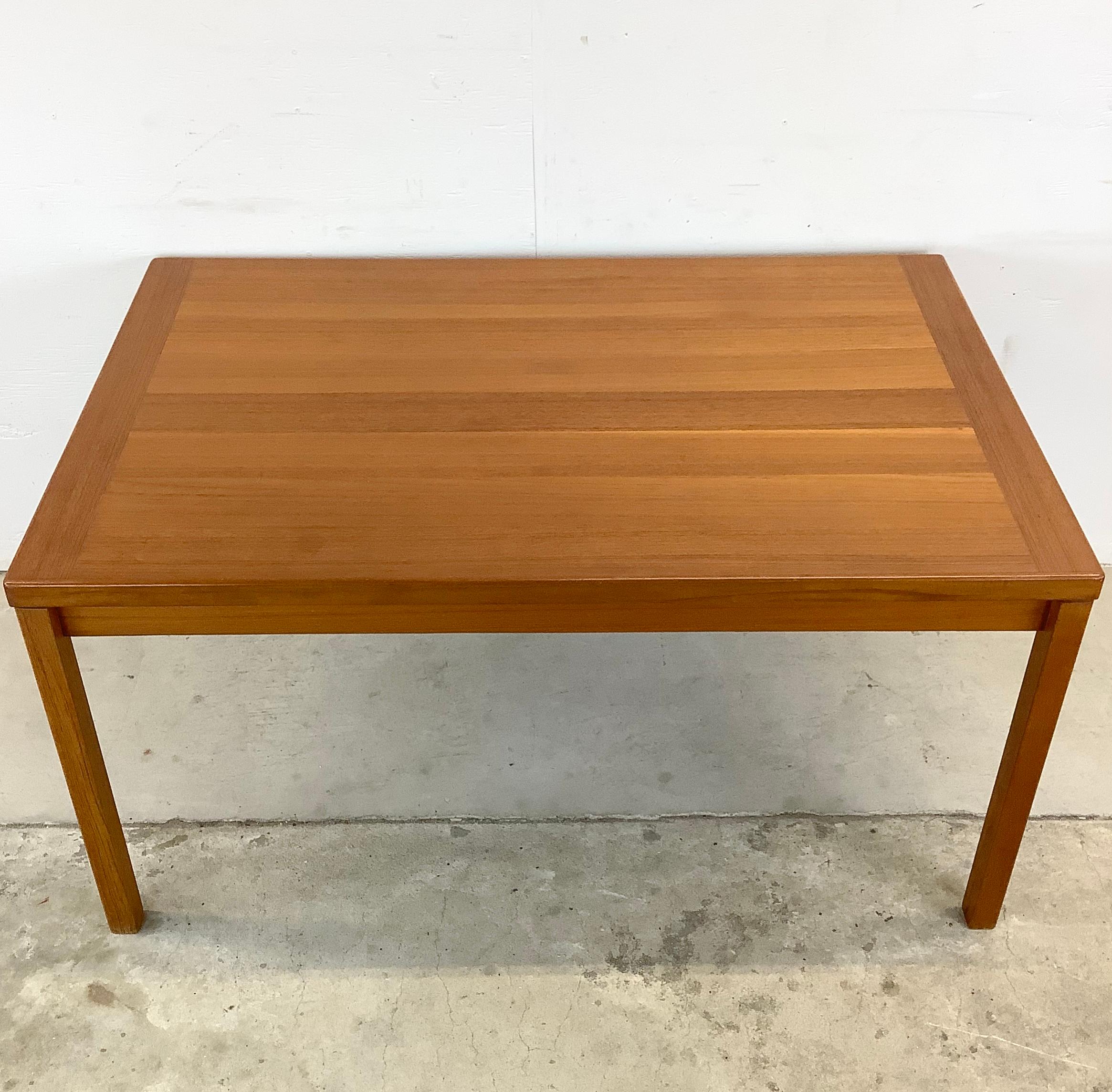 This Vintage Teak Draw Leaf Dining Table is the epitome of timeless elegance and Scandinavian Modern style. A true gem that brings warmth, character, and a touch of mid-century Danish charm to any dining space. Crafted from vintage teak wood, this