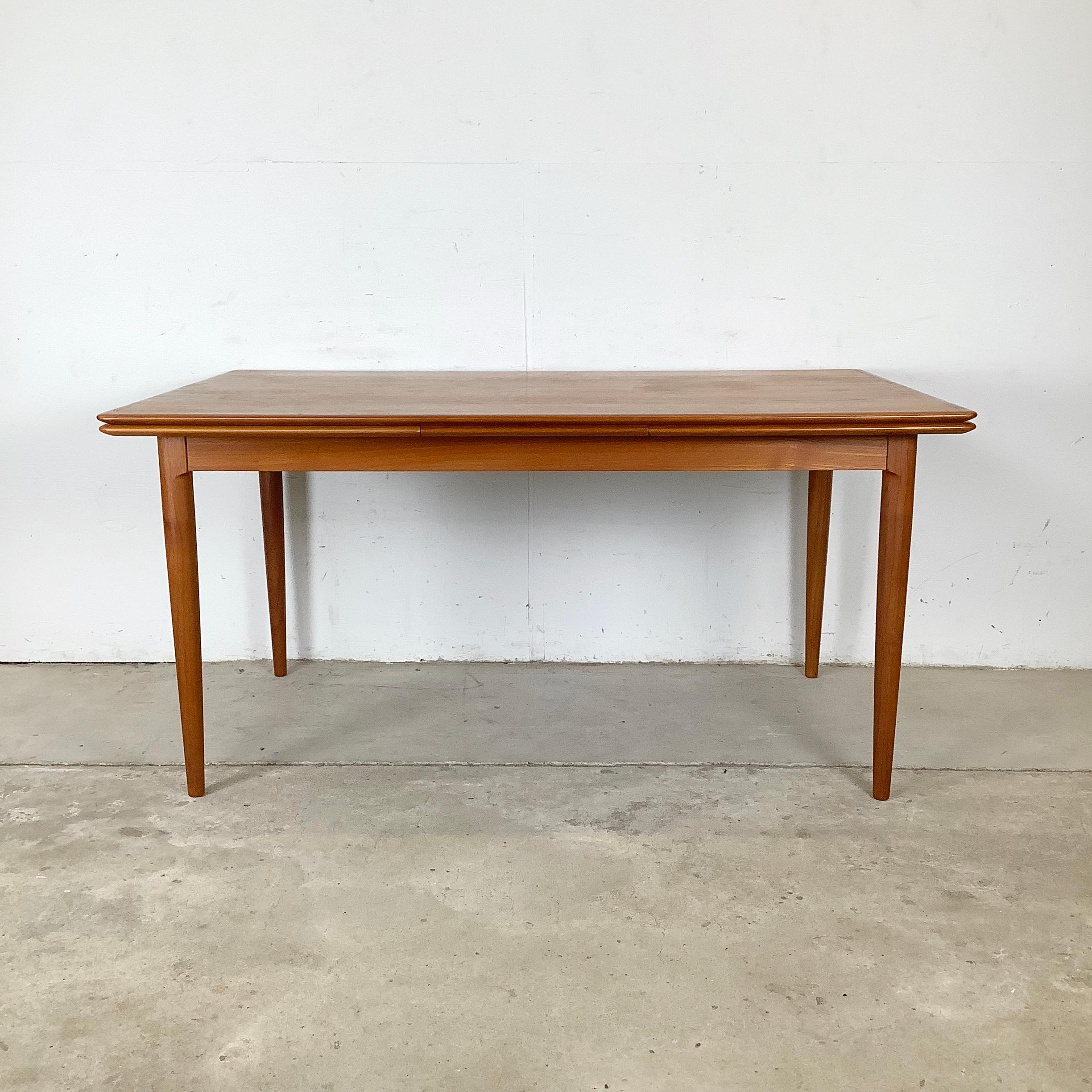 This exceptional mid-century teak dining table, designed by Skovmand & Andersen for Moreddi Møbler, exemplifies the refined craftsmanship of Danish modern design. With its seamless functionality and sculptural elegance, this piece captures the