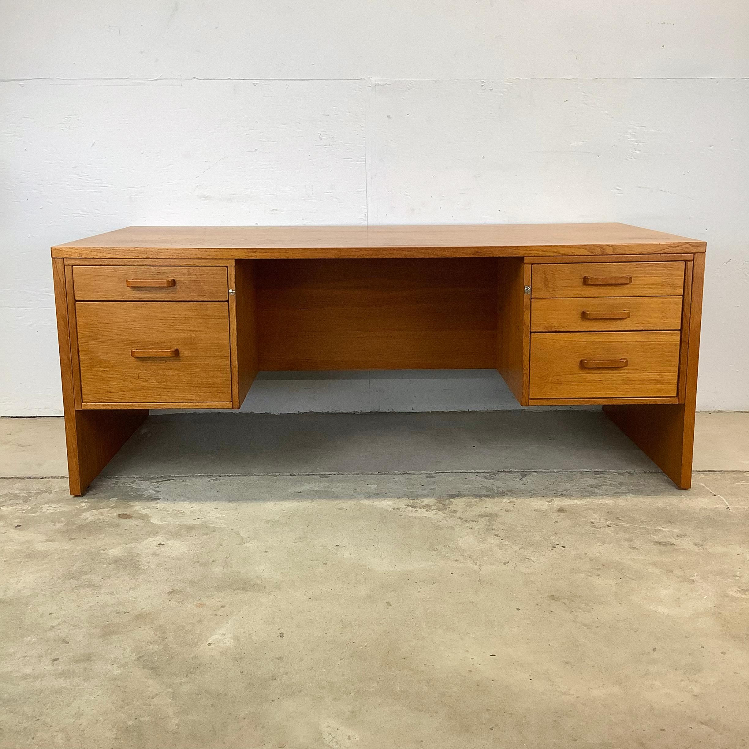 This Vintage Scandinavian Modern Teak Executive Desk from Jesper Furniture makes a timeless masterpiece that combines elegant design with exceptional craftsmanship. Crafted with rich teak finish, this executive desk exudes warmth and sophistication,