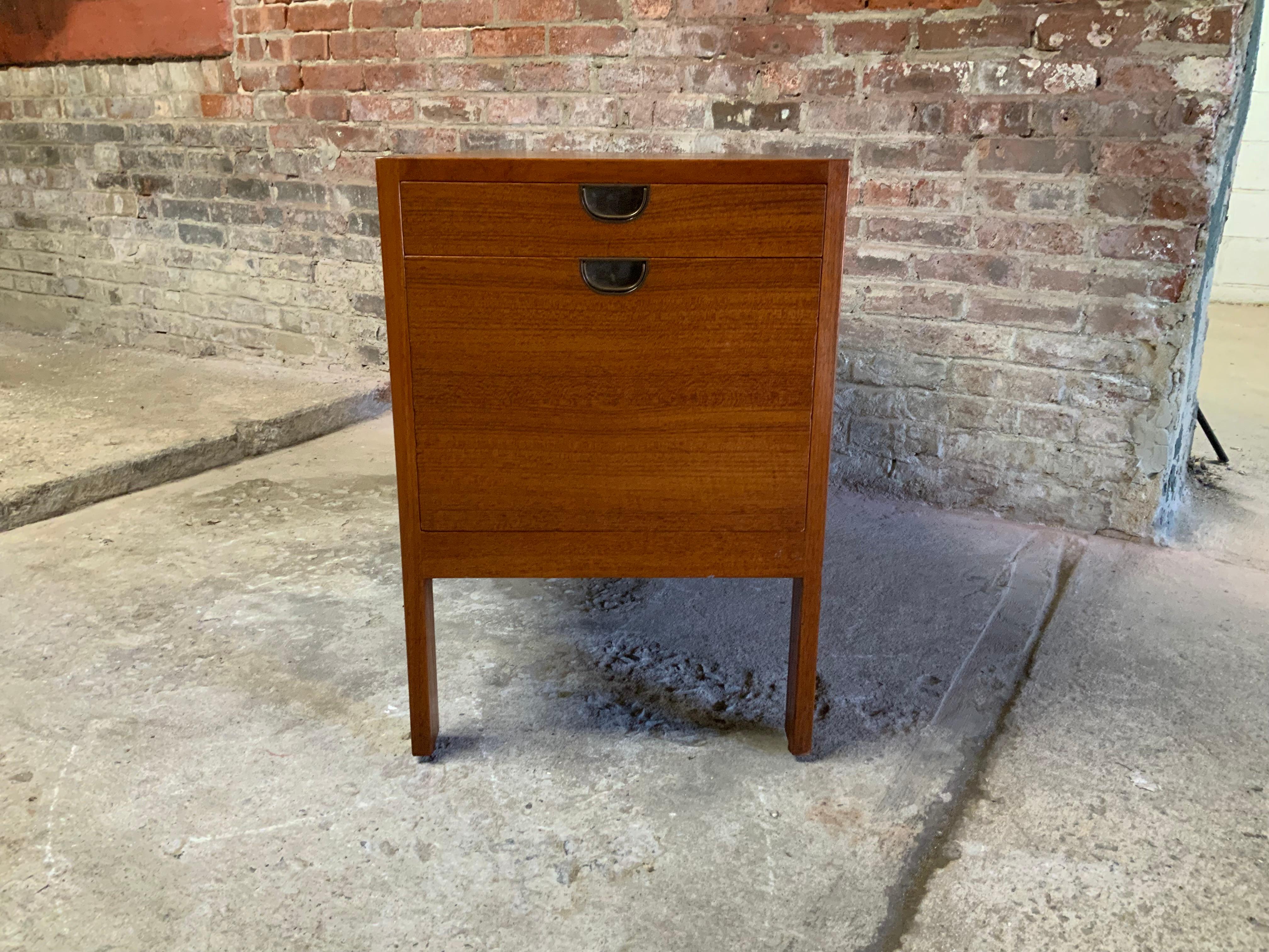 Two drawer with recessed brass pull Scandinavian Modern teak file cabinet. Deep bottom drawer for hanging files with a smaller top drawer. Circa 1960. A great free standing cabinet for the office. All glides and levelers are intact. 

Good overall