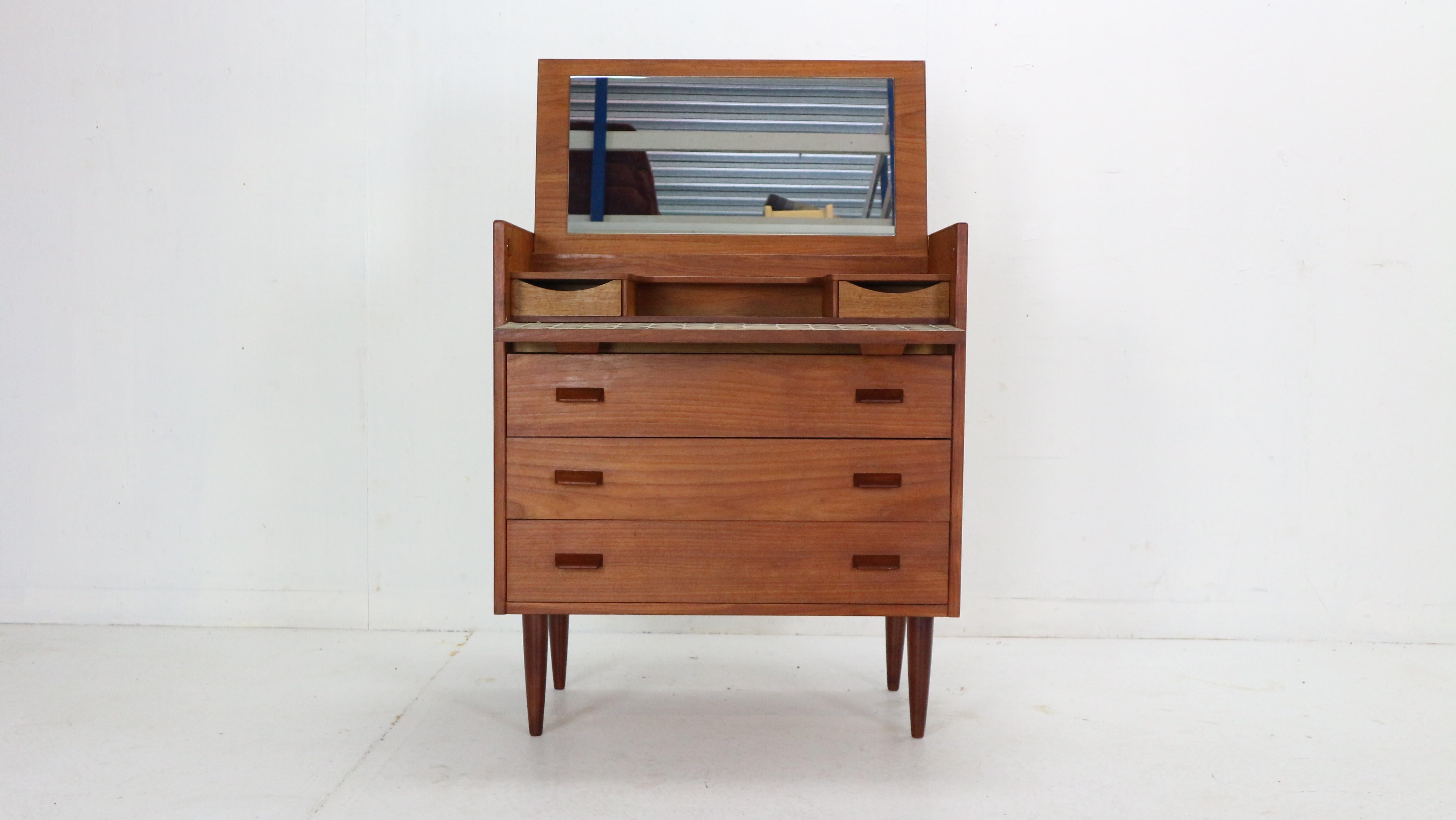 Scandinavian Modern period teak make up table with flip top beaming small cabinet- dresser made in 1960's period Denmark.

Made of teak wood. Mirror glass has been replaced with the new one, no s ucratches.
Three spacious drawers in the centre of
