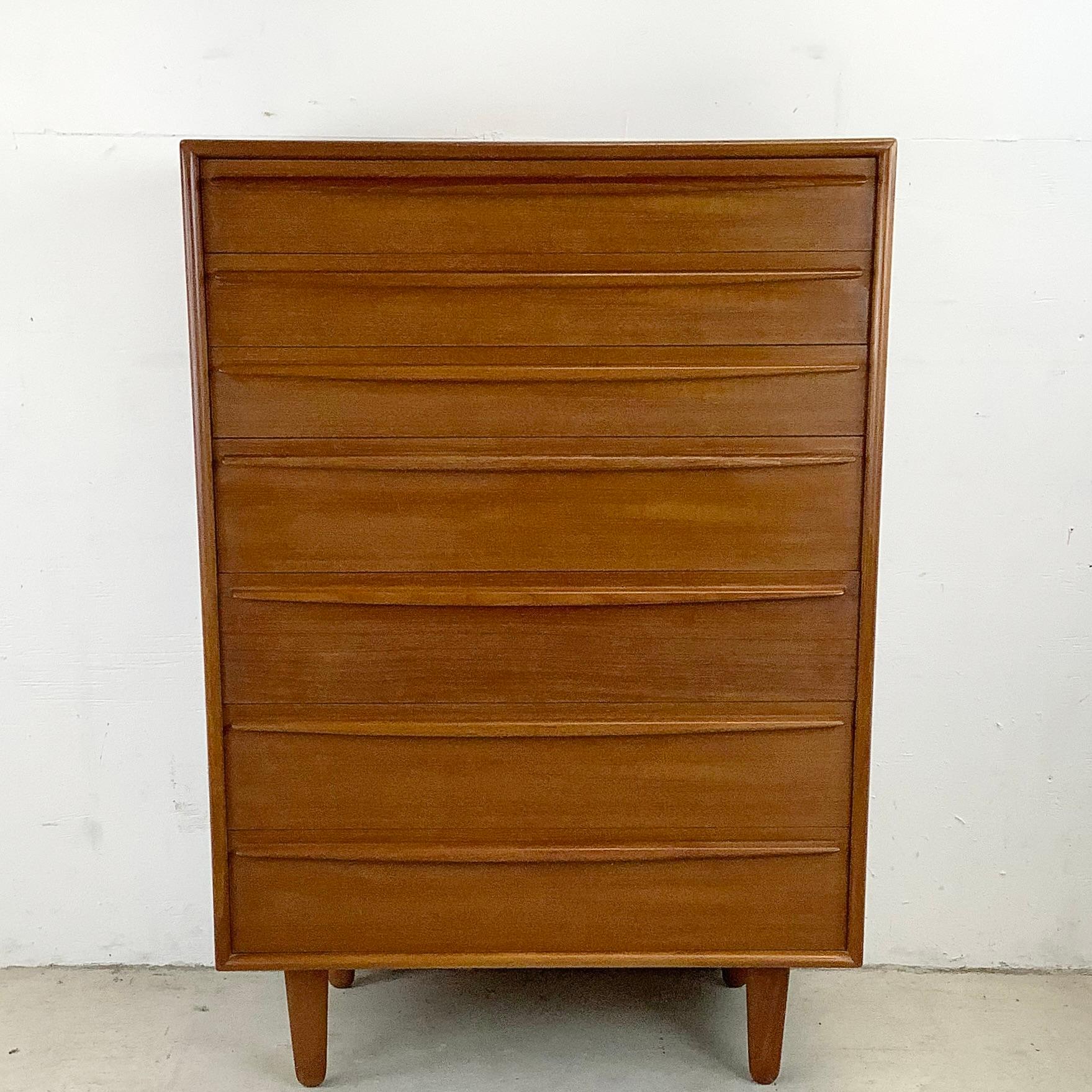 Beautiful Scandinavian modern highboy dresser from Lyby Mobler features a set of seven dovetailed drawers. The stylish Danish modern dresser offers plenty of storage in a striking vintage teak package. The quality Danish manufacture, clean modern
