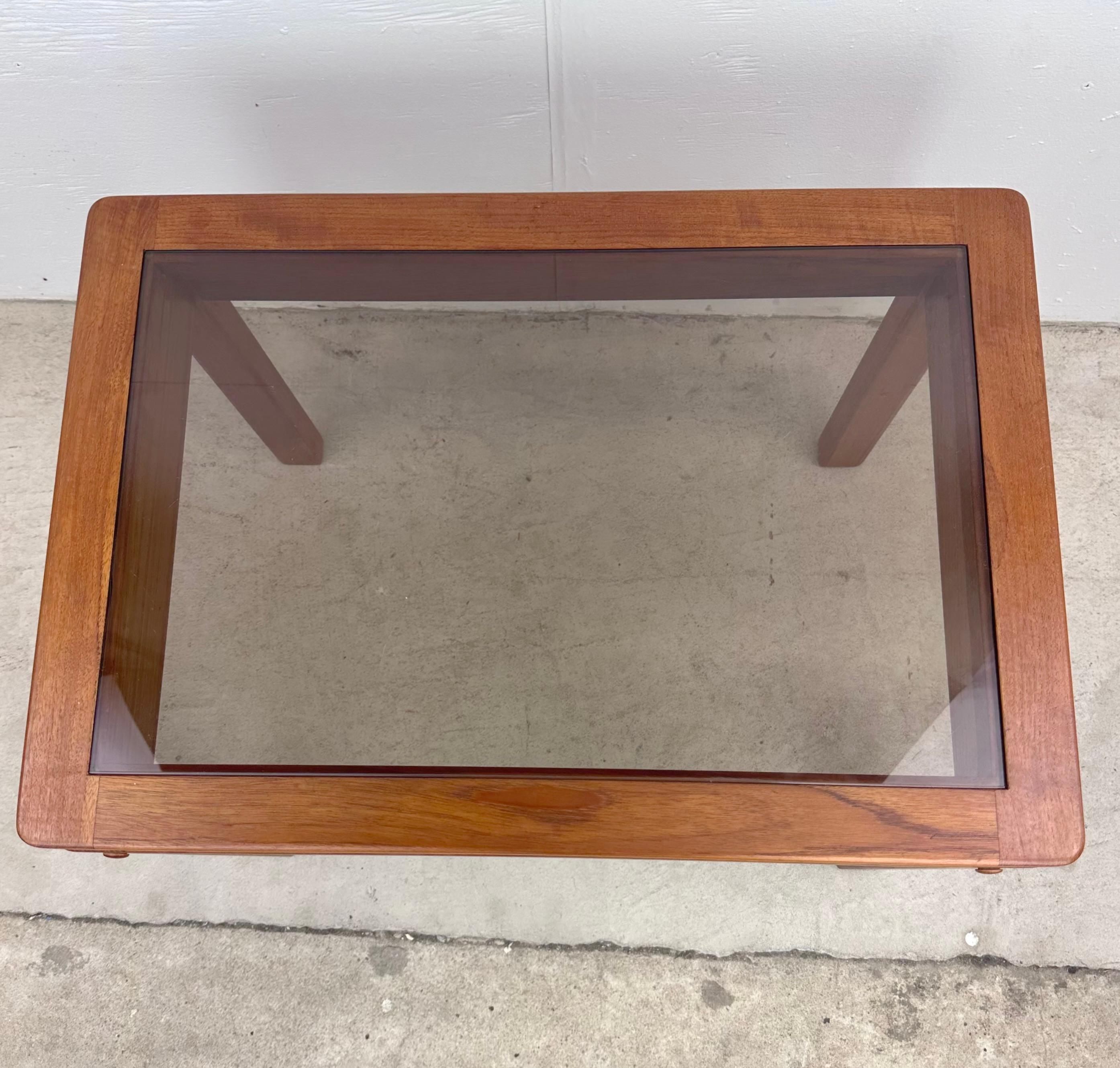 This Mid-Century Modern Teak End Table with smoked Glass Inset offers a timeless blend of style and function. Looking for an end table that seamlessly combines classic Scandinavian design, functionality, and a touch of mid-century charm? Look no