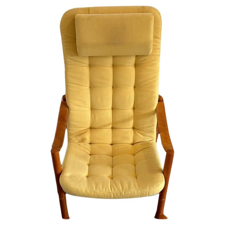 Scandinavian modern teak leather safari lounge chair with yellow upholstery. Very clean chair with thick leather strap armrests and solid teak frame. Chair only. Made in Norway. Located in Brooklyn NYC.

Chair measures 
25” w x 32” d x 40” high - SH