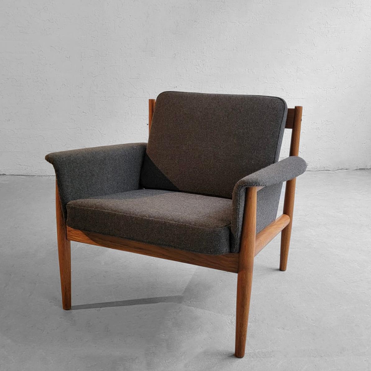 Scandinavian modern, lounge chair by Grete Jalk for France & Son features a teak frame with upholstered seat and back removeable cushions and covered arms in gray wool blend.