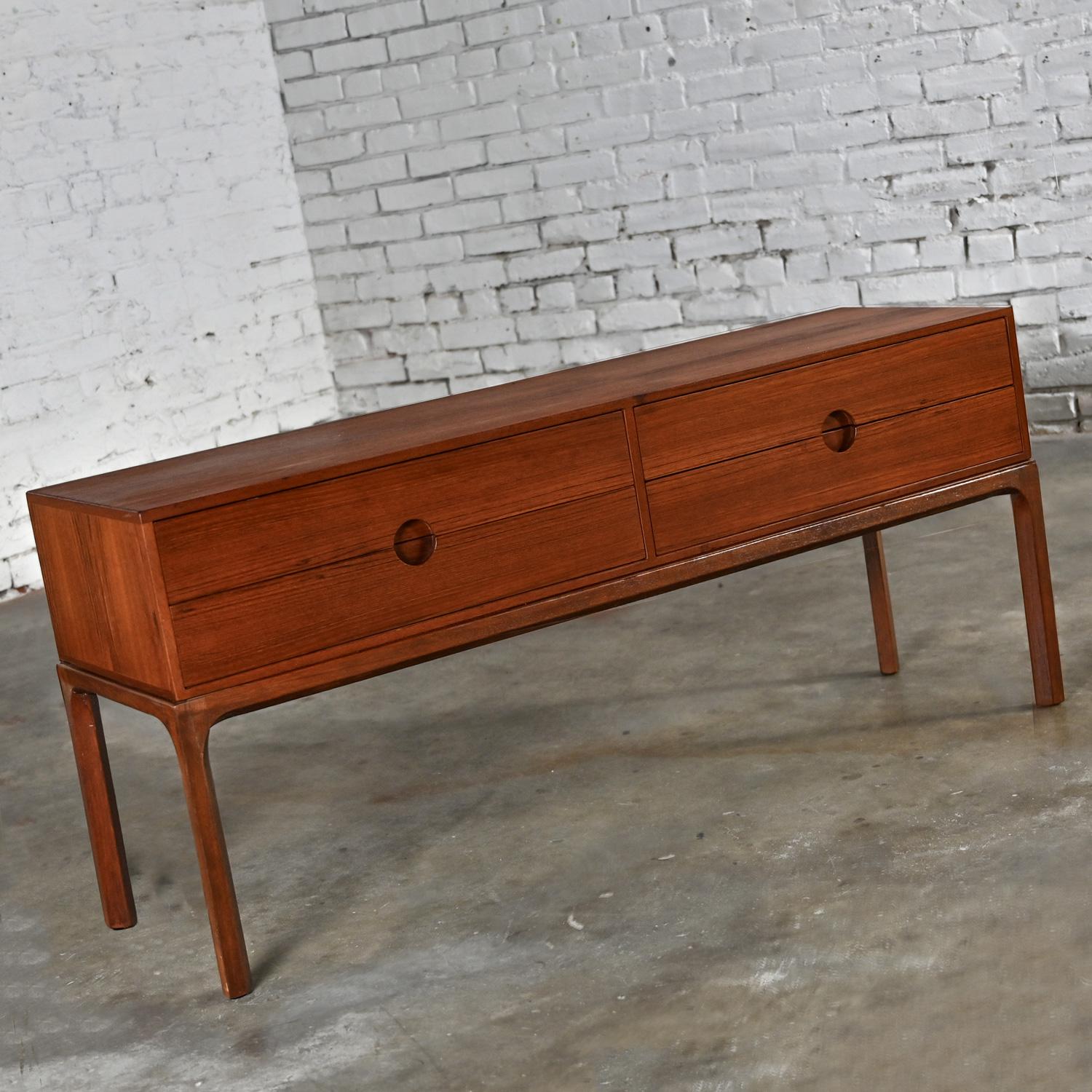 Incredible 1950-1960’s Scandinavian Modern teak 4 drawer low cabinet sideboard (or bench) Model #394 by Kai Kristiansen for Aksel Kjersgaard Odder. This piece has been attributed based upon its stamped mark, archived research including online