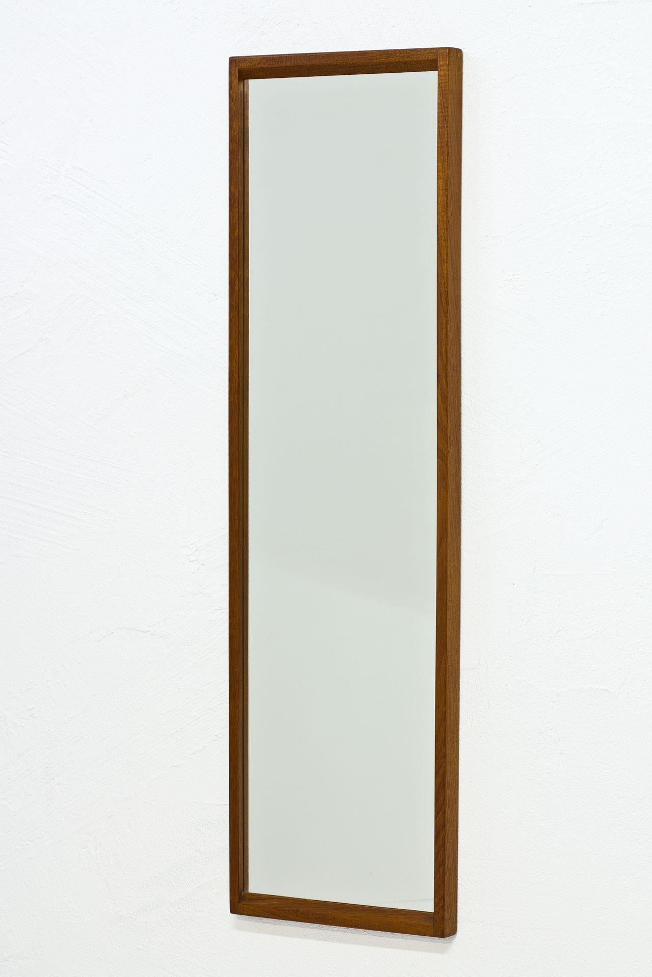 Rectangular wall mirror N° 114 designed by Kai Kristiansen. Produced in Denmark by Aksel Kjersgaard during the 1950s. Solid teak frame. Signed on the back.