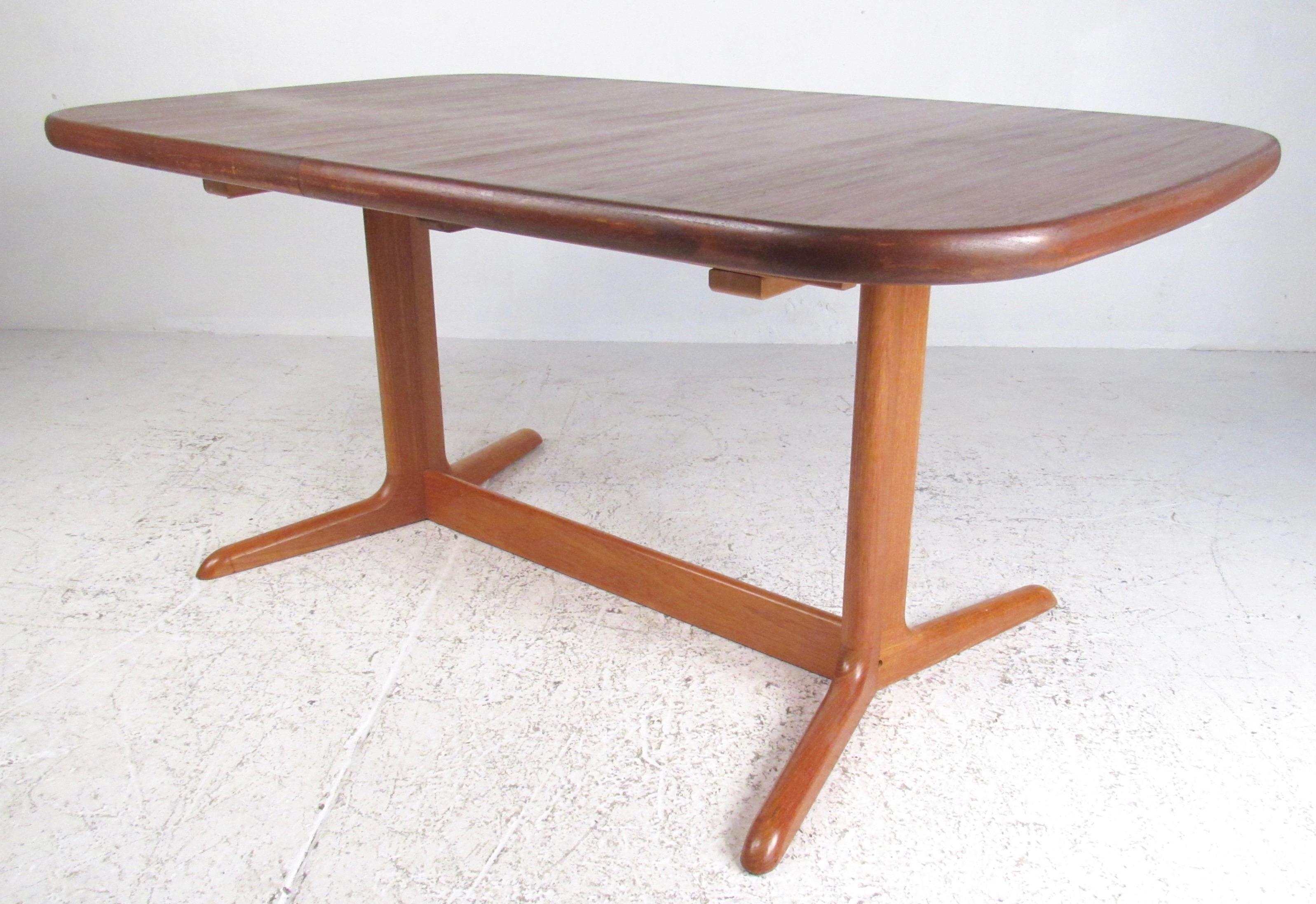 This stylish midcentury dining table features a trestle style base and thick teak finish top. Oval style table makes a striking Scandinavian modern addition to kitchen or dining room. Please confirm item location (NY or NJ).