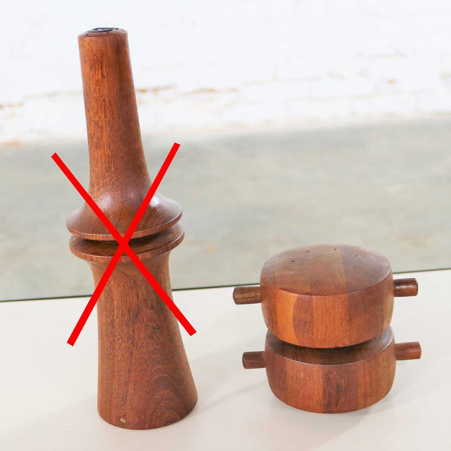 EDITED: TALL PEPPER MILL SOLD - ONLY SHORT ONE AVAILABLE
Two, but priced individually, handsome Scandinavian Modern teak pepper mills designed by Jens Quistgaard for Dansk designs. They are both fitted with Peugeot Lion grinding blades and in
